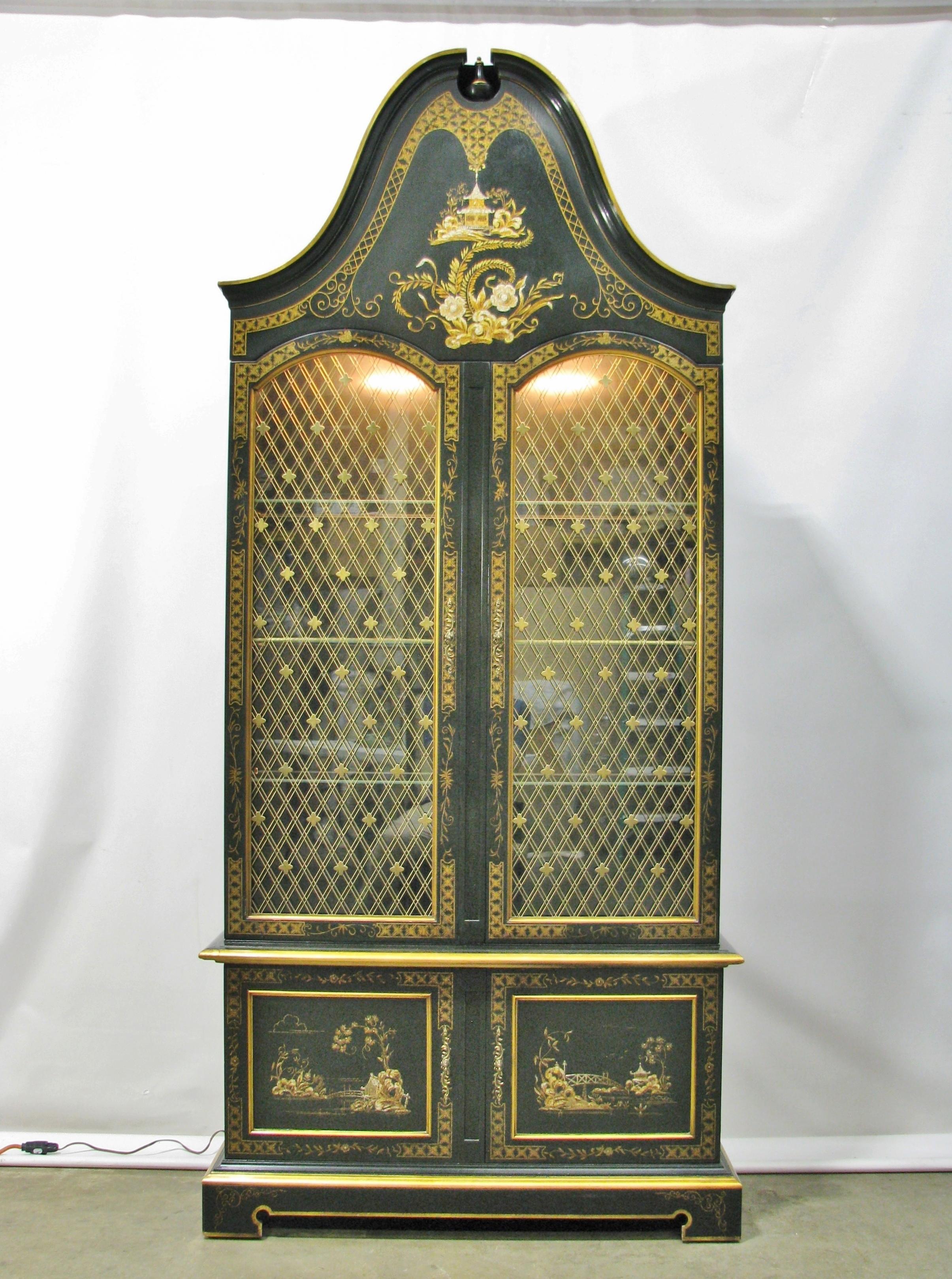 Chinoiserie display cabinet by luxury furniture brand John Widdicomb. This 2 piece cabinet is in excellent, clean original finish and condition. It features arched dome bonnet top, gloss lacquered finish with Asian-inspired painted scenes with