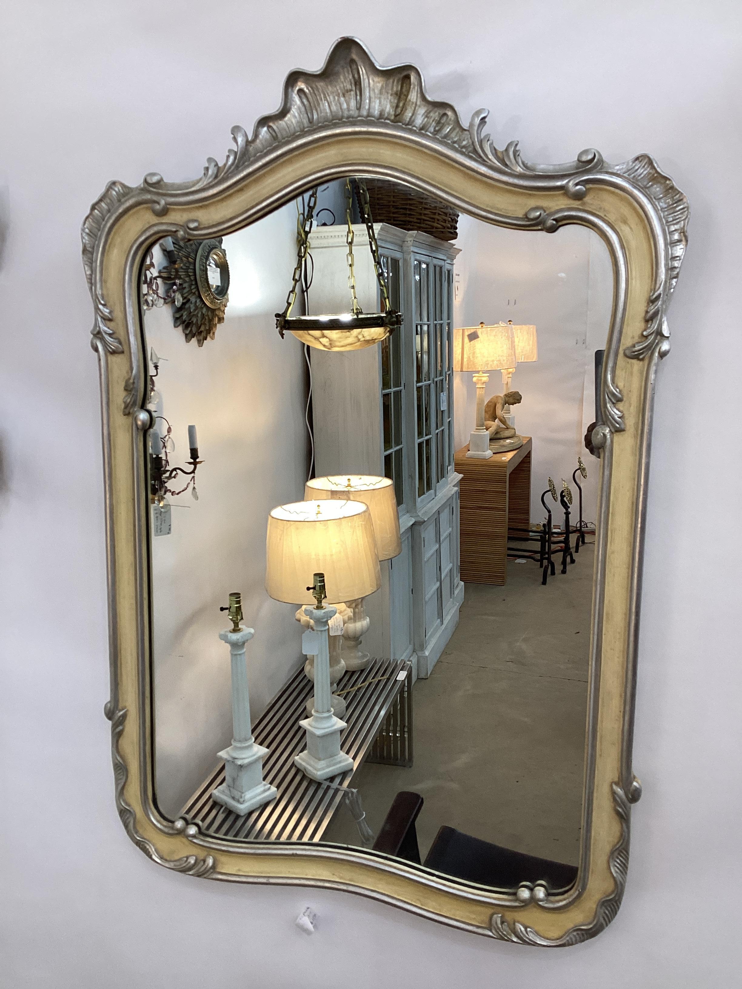 Vintage John Widdicomb French Style Silver Leaf and Painted Mirror. Cream painted frame with silver leaf accents in the Louis XV style. Retains original John Widdicomb plaque on the back of mirror. In very good food vintage condition.