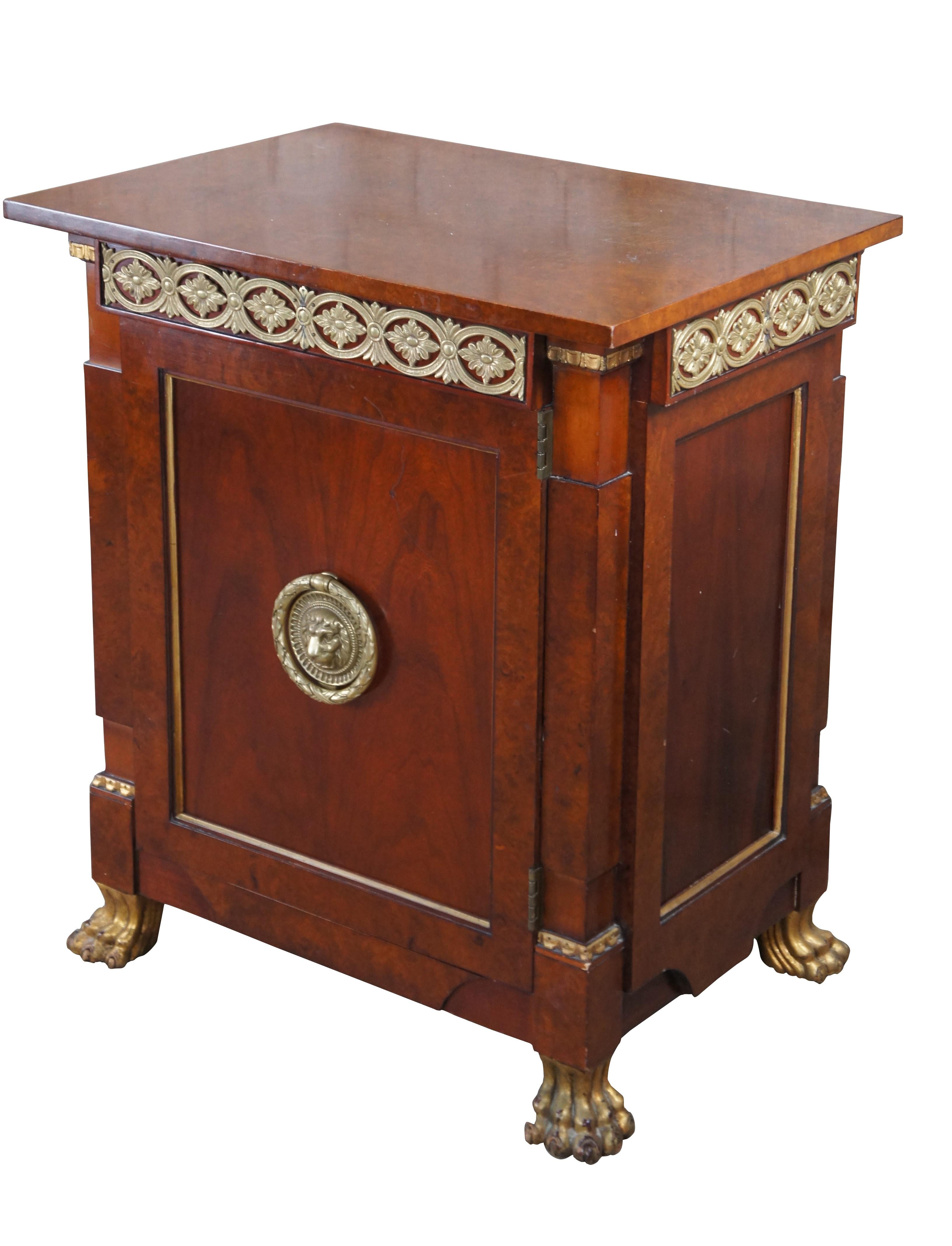 An exceptional nightstand or low cabinet by John Widdicomb. Part of their Russian Collection designed by Chad Womack in the 1970s. Features a cherry case with inset panels trimmed in brass, burled surfaces, gilt ormolu and paw feet. Features a