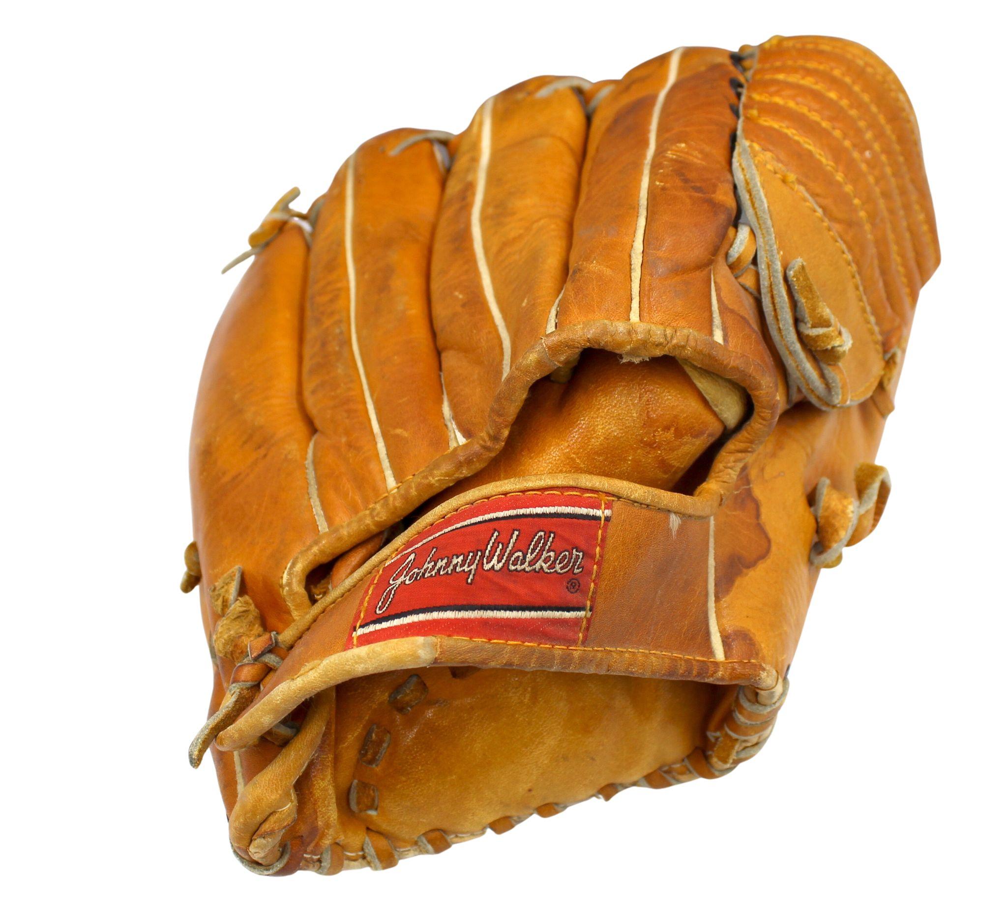 This is a vintage Johnny Walker baseball glove from the early 1960s . The glove has a barrel web design and laced fingers. The model number is visible along the heel pad of the glove “Johnny Walker Model No. FG-202.” It is stamped with “Pre-Formed