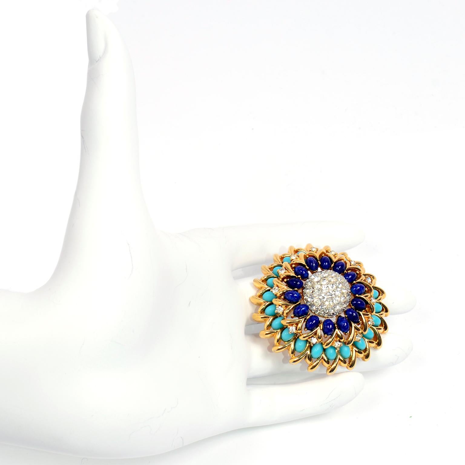 This vintage Jomaz statement brooch has a beautiful gold tone base with turquoise and lapis blue oval stones and clear rhinestones. This domed brooch is in excellent condition and is stunning in person!  The back is marked Jomaz.
DIAMETER: 2