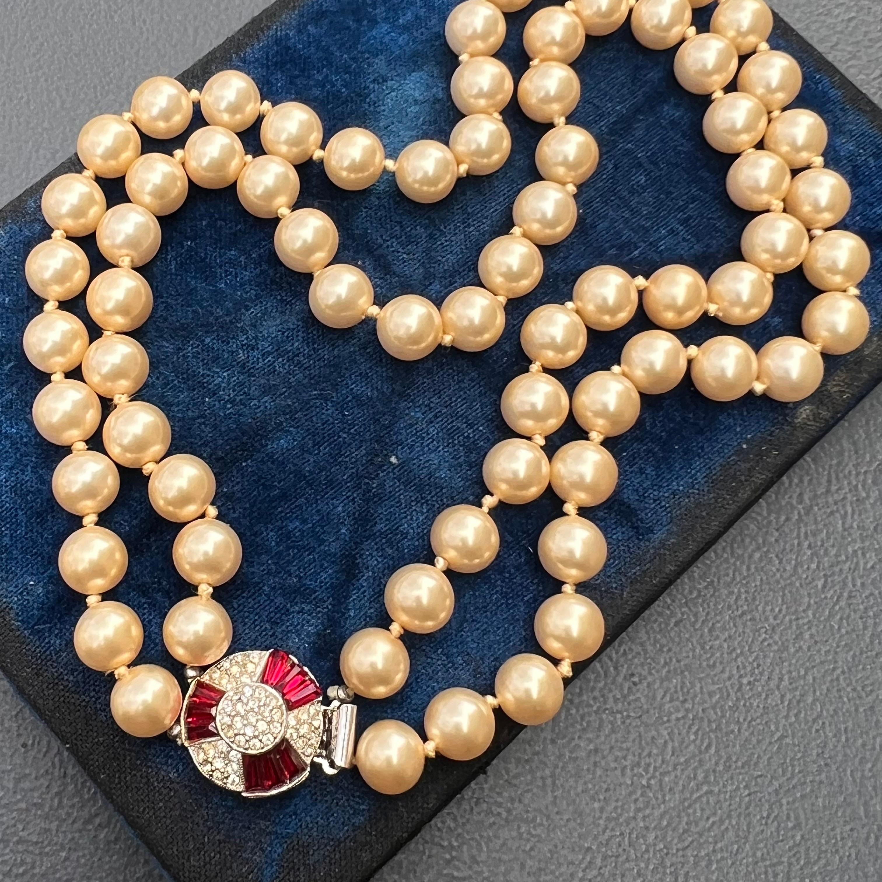 Absolutely fabulous rare Signed Jomaz with pat number 2583988 invisible setting clip-on earrings and matching hand knotted faux pearl choker necklace . Ruby color stones are set on an chrome plated  metal with pave stones all around on front side