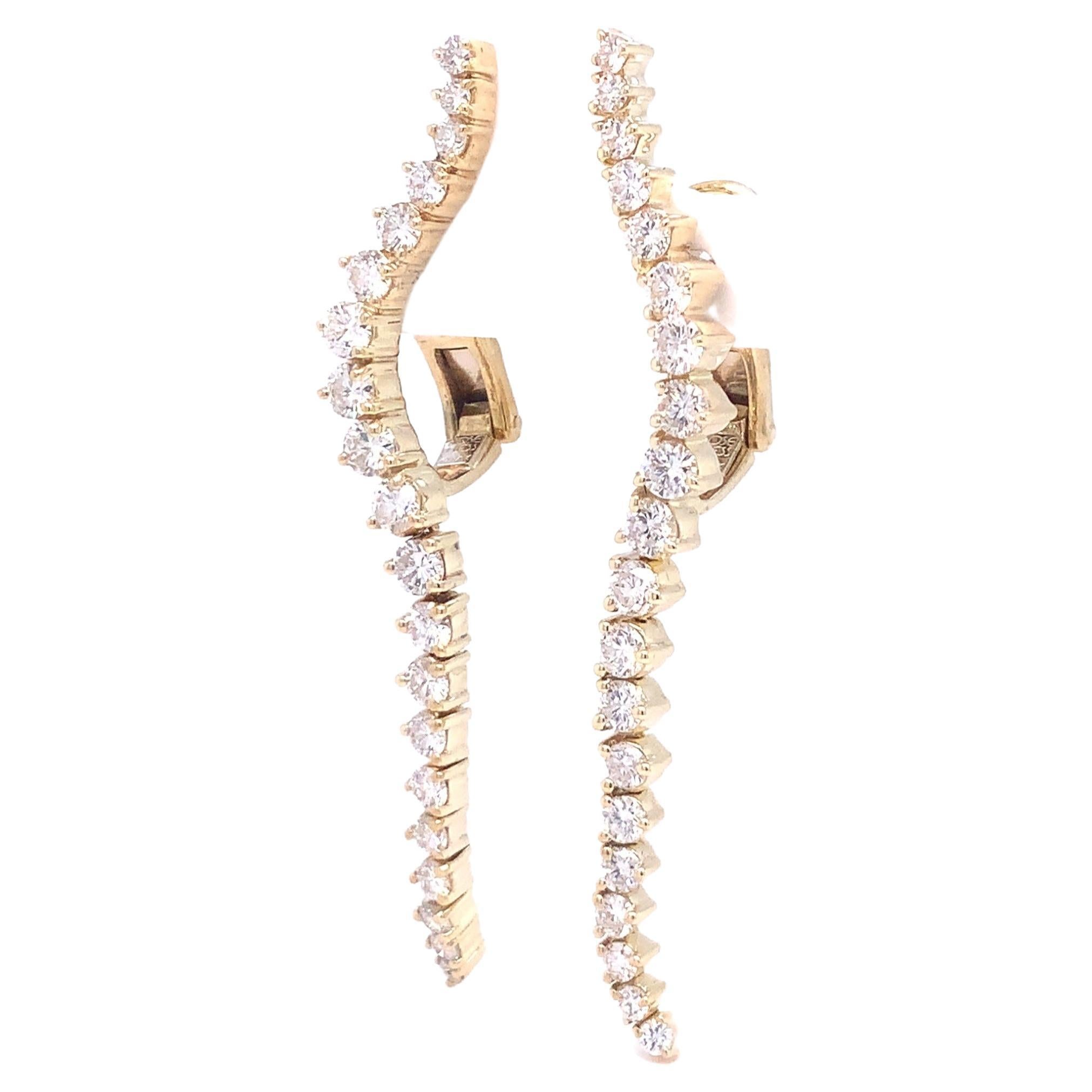 Stunningly crafted diamond drop earrings from renowned designer Jose Hess boast 14 karat yellow gold construction. 40 round brilliant cut diamonds weighing 2.65 carats and rated F-G in color and VS in clarity adorn the 2.00-inch-long pieces, marked