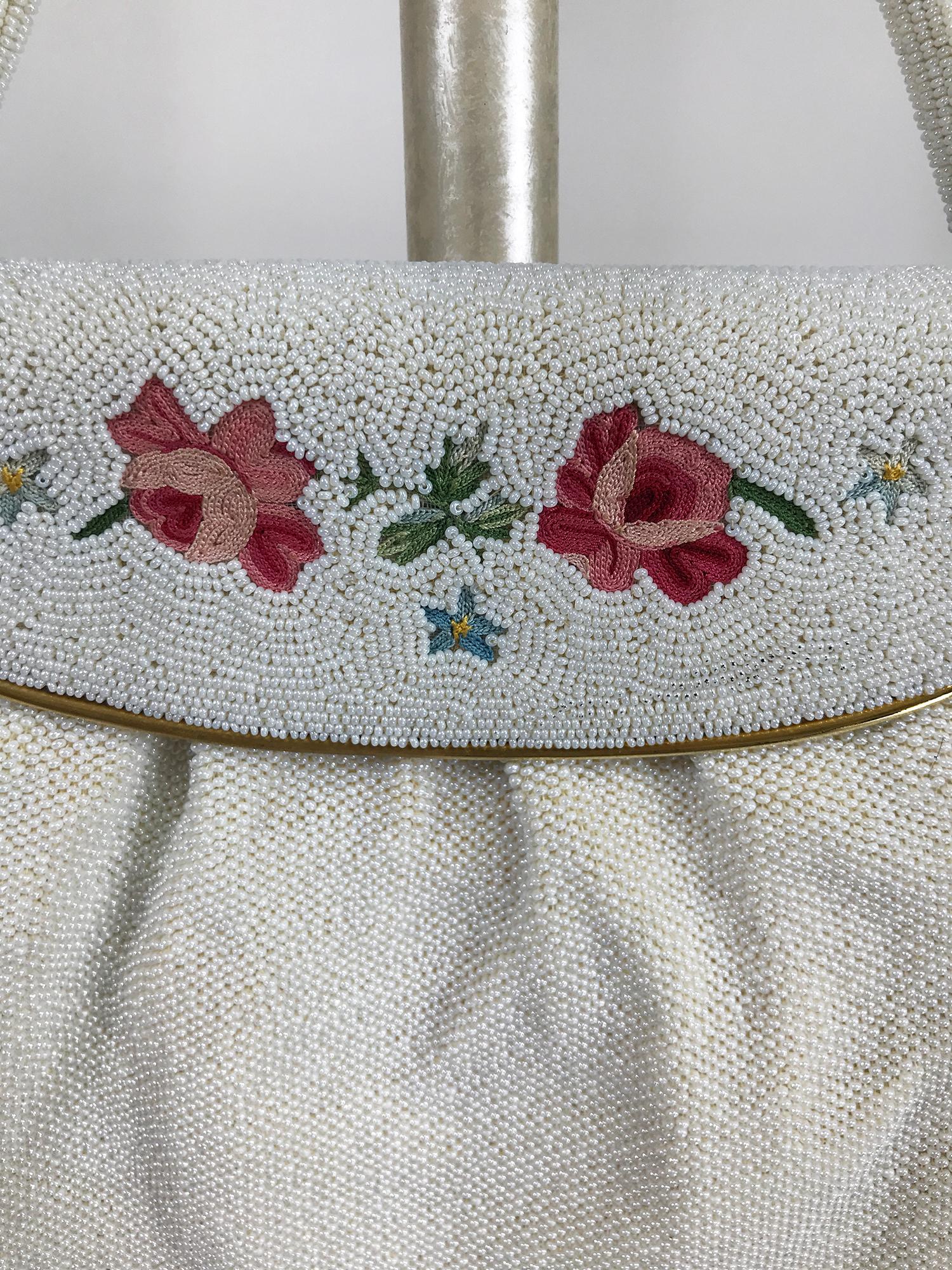 Vintage Josef pearl with embroidery evening bag with gold metal frame from the 1950s. This beautiful bag is hand beaded with tiny pearls, the flap closure has a gold metal frame and clasp that is embroidered with pastel flowers and set with tiny