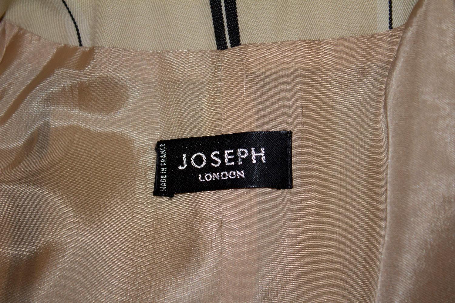 A fun vintage jacket by Jospeh London. In a cream wool with dark stripe , the jacket has a three button front opening, and a three button cuff detail, and three pockets on the front. It is fully lined. Made in France , size 40. Measurements, Bust up