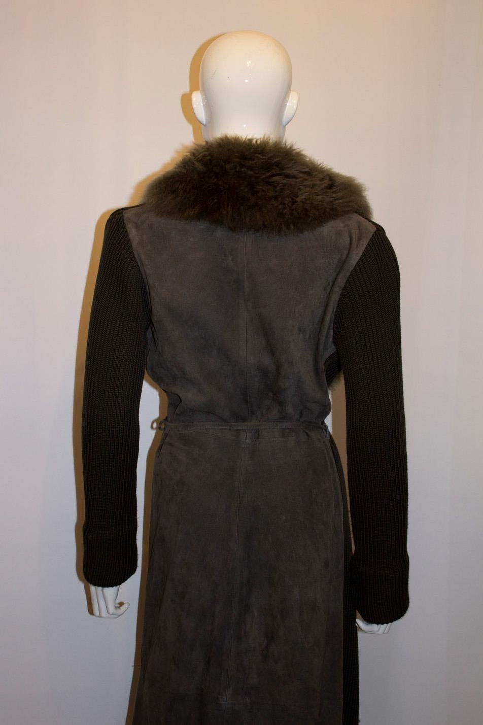 A warm and wonderful long  vintage jacket by Joseph. The jacket is in an attractive olive green colour and is a mix of knit  and suede with a faux fur collar.  It has a tie belt. 
Size s Measurements : Bust 36'', length 53''