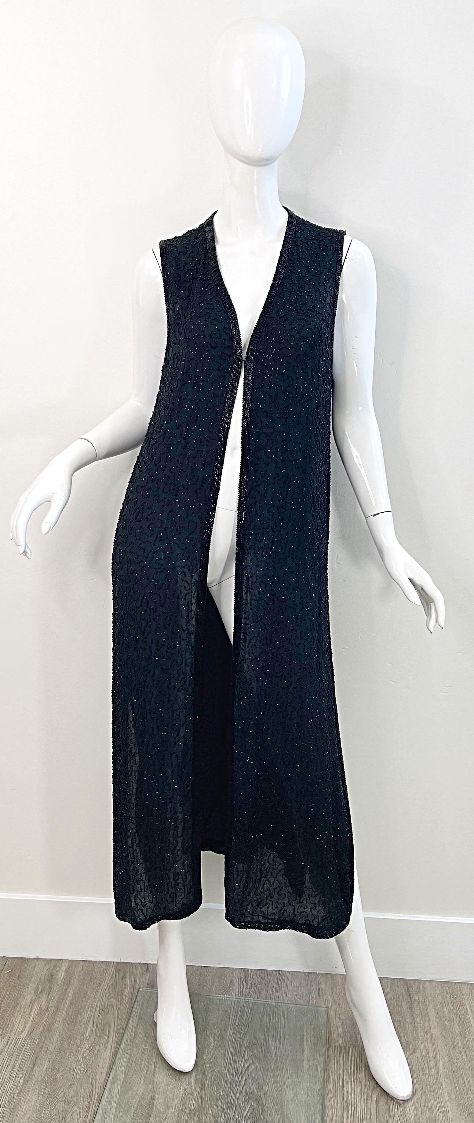 Chic vintage early 90s JUDITH ANN black silk chiffon fully beaded sleeveless duster maxi vest ! Features thousands of hand-sewn black seed beads throughout. Single hook-and-eye closure at bust. Vents at each side of the hem. Easy to dress up or