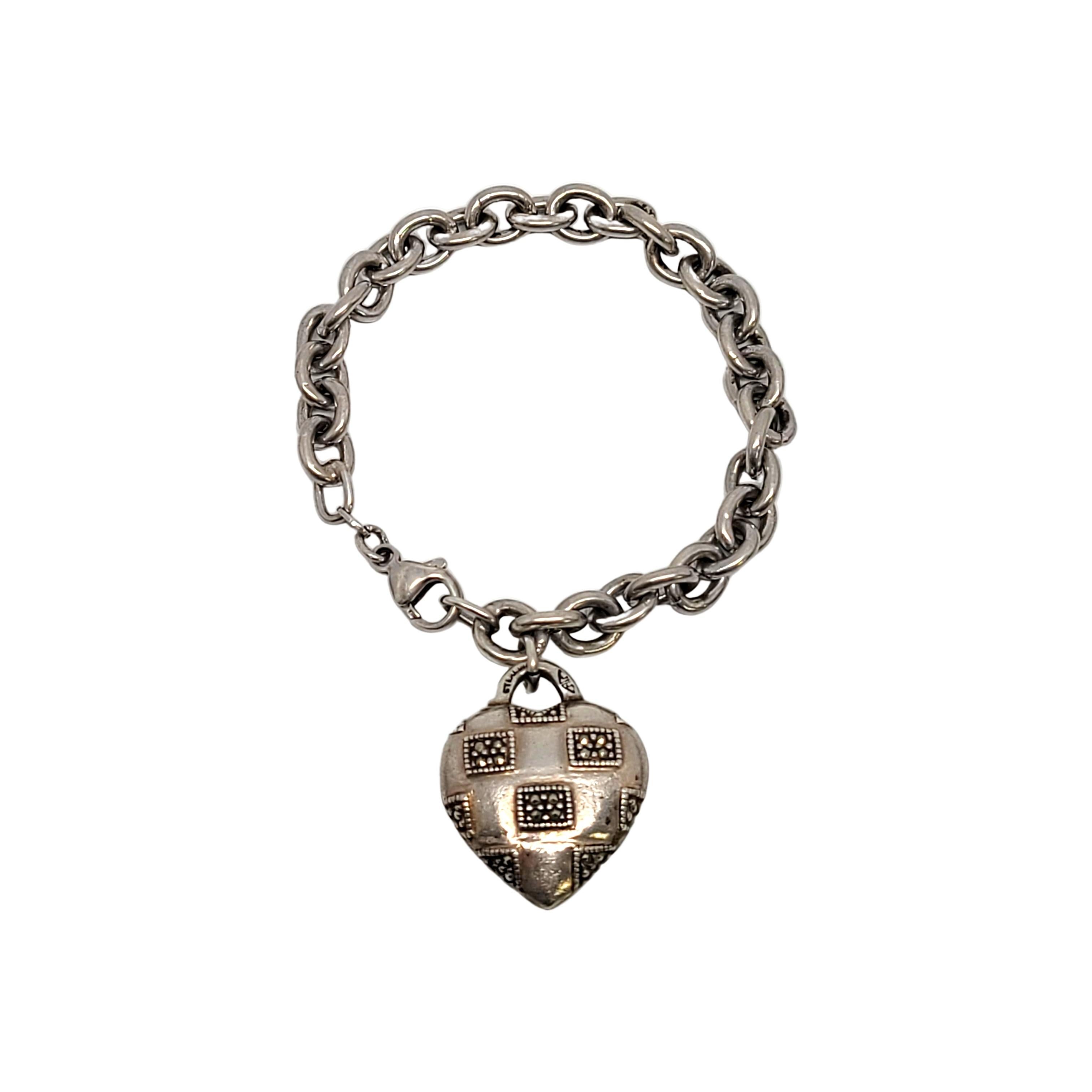 Sterling silver bracelet with marcasite heart dangle by Judith Jack.

This lovely rolo link bracelet features a dangling puffy heart accented with marcasite.

Weighs approx 18.3dwt, 28.5g

Marked JJ in triangles STERLING on the bale of the heart.