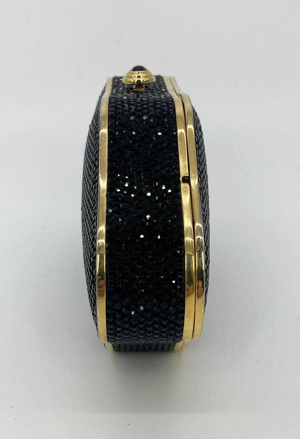 Judith Leiber Black Crystal Large Minaudiere in very good condition. Black swarovski crystal exterior trimmed with gold hardware in a unique large trapezoid shape. Top button closure opens to a gold leather interior with attached gold chain shoulder