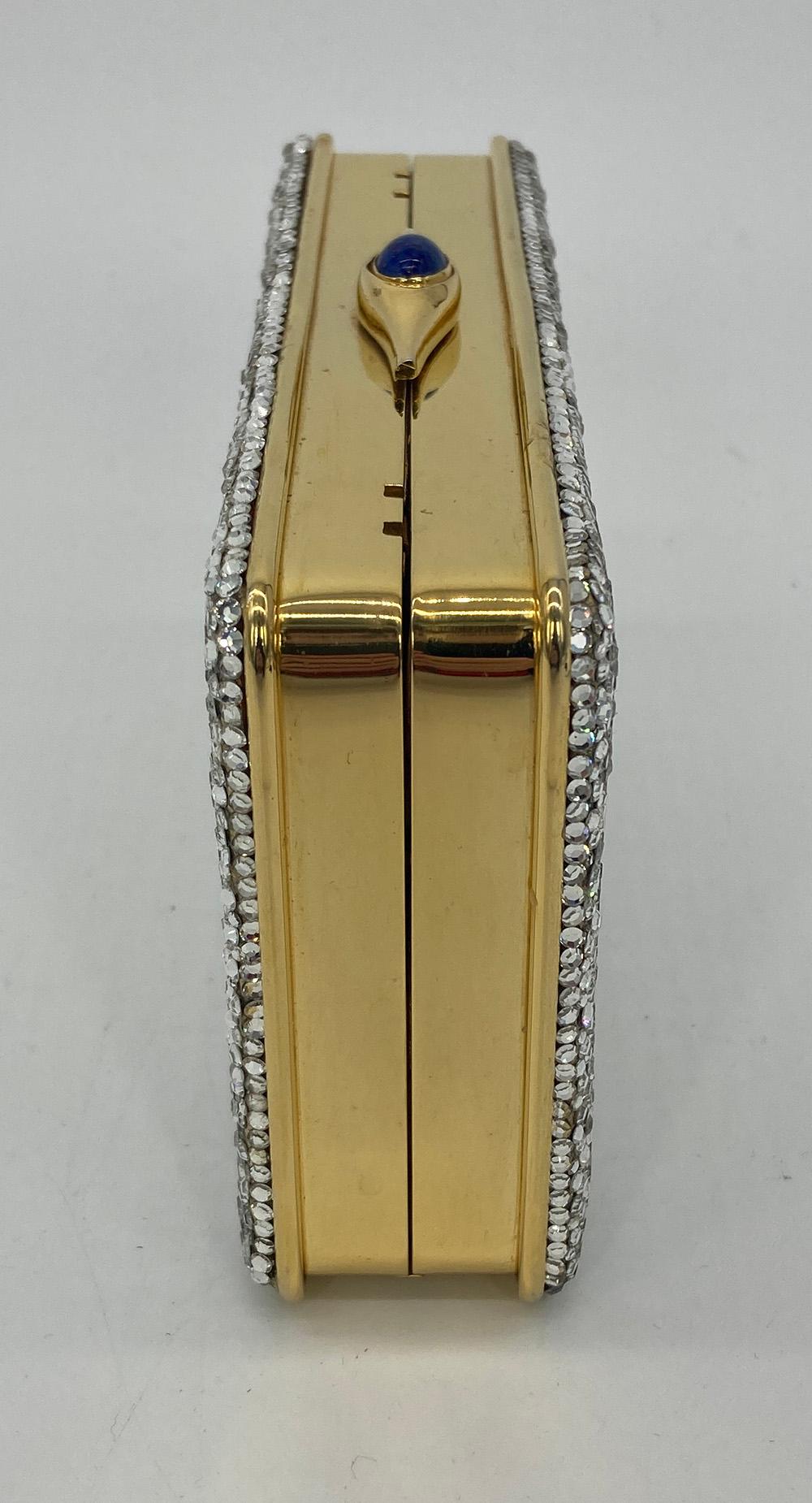 Judith Leiber Clear Crystal Small Rectangle Minaudiere in very good condition. Clear crystals over leather base exterior trimmed with gold hardware and a blue lapis stone top button closure. Gold leather interior with attached chain shoulder strap.