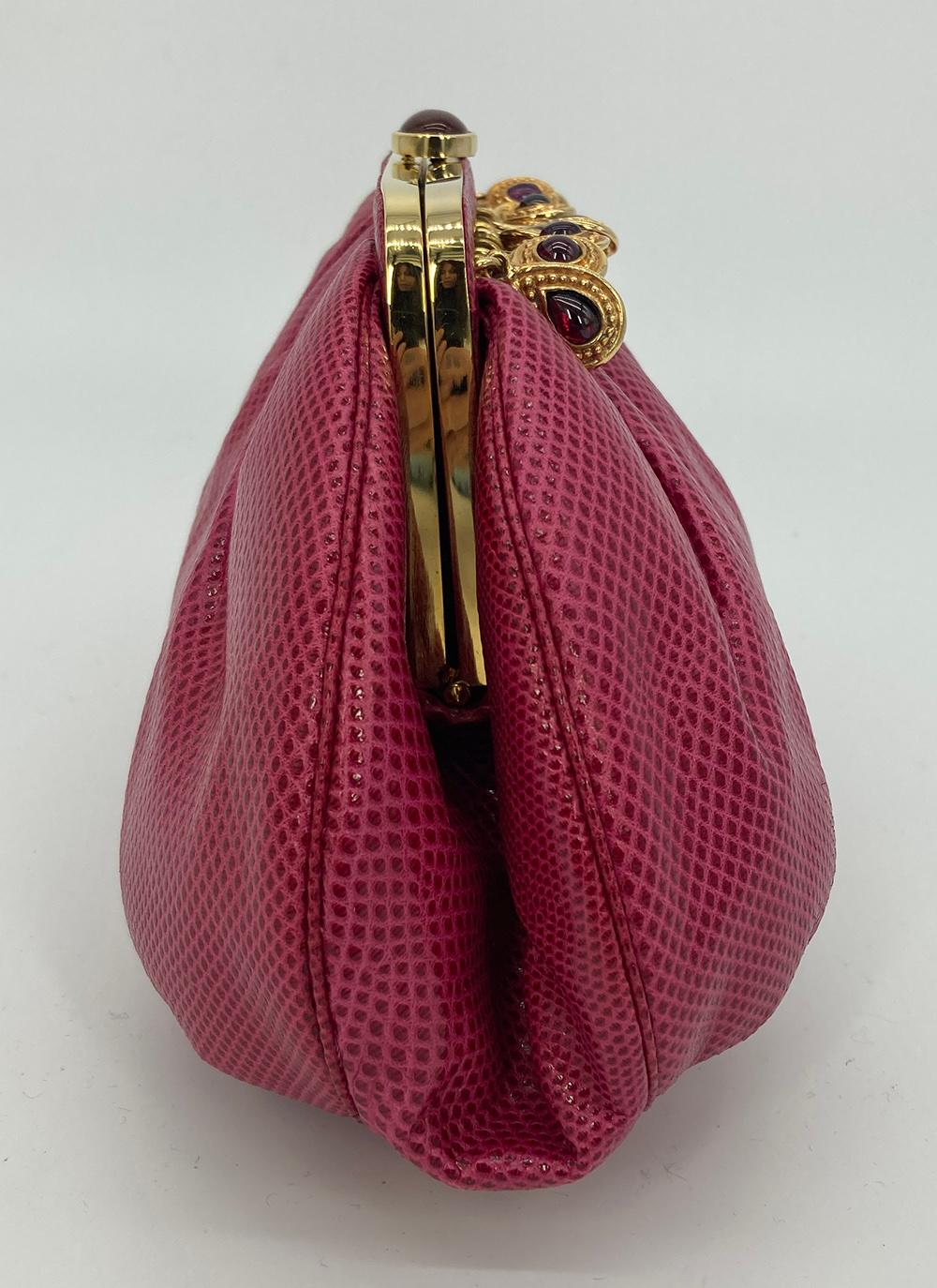 Vintage Judith Leiber Dark Pink Lizard Clutch c1980s in good condition. Dark rose lizard exterior trimmed with gold hardware and various gemstone charm embellishments along top front edge. Top button closure opens to a matching rose nylon interior