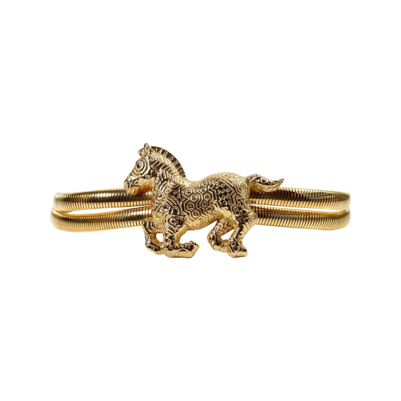 Vintage Judith Leiber Gold Horse Belt Circa 1980s. These belts were so iconic in the 1980s and you saw them on every supermodel.  They were worn on everything from skirts to jackets to jeans. This one has double rows with a large horse on the front