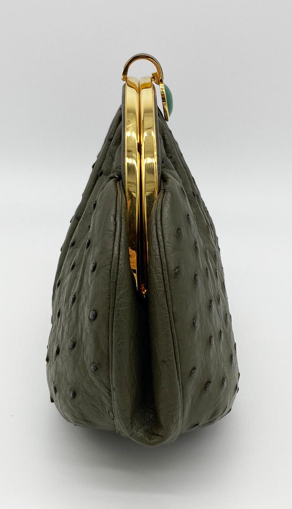 Vintage Judith Leiber Green Ostrich Clutch in excellent condition. Green ostrich leather exterior trimmed with gold hardware and jade stone. Top lift closure opens to a green satin interior with 2 side pockets and attached matching leather shoulder