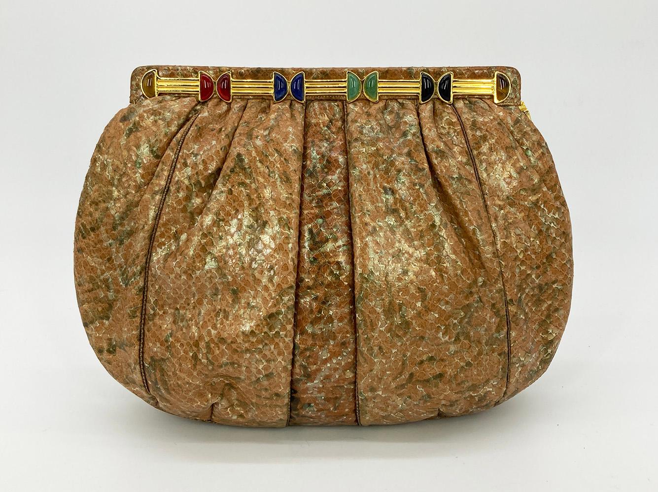 Vintage Judith Leiber Natural Tan and Brown Snakeskin Clutch in excellent condition. Tan and brown python exterior trimmed with gold hardware and multi color gemstones. Side pull latch closure opens to a tan nylon interior with one slit and one zip