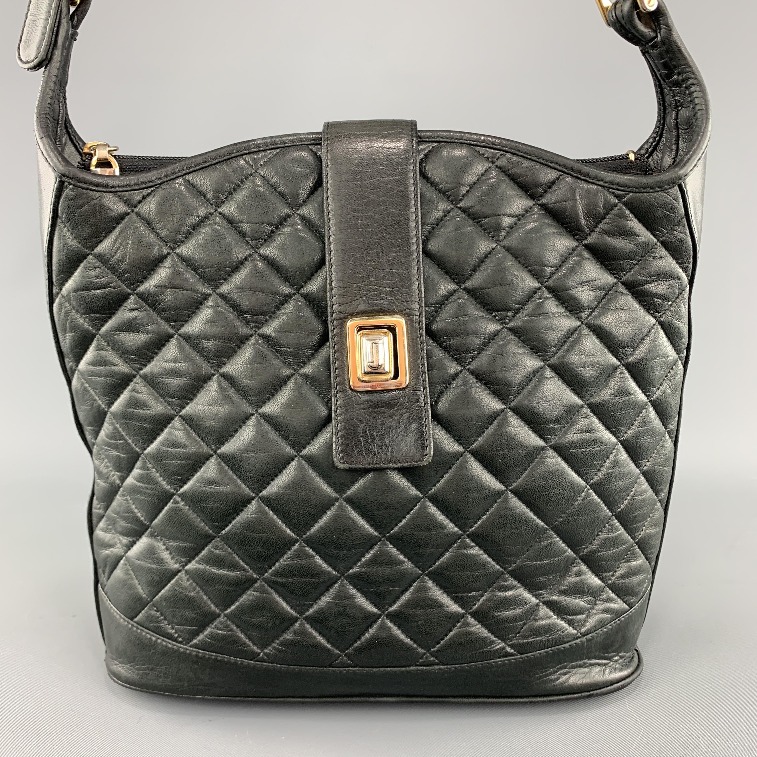 Vintage JUDITH LEIBER shoulder bag comes in quilted leather with gold and silver tone hardware, top strap closure, adjustable shoulder strap, and double compartment red interior. Aging and wear throughout. As-is. Made in Spain.

Good Pre-Owned