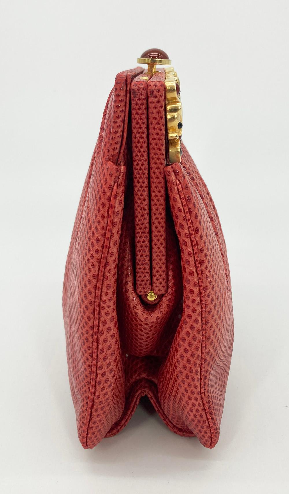 Vintage Judith Leiber Red Lizard Clutch in very good condition. red lizard exterior trimmed with gold hardware and unique floral filigree gemstone embellished front top. Top button closure opens to a red nylon interior with one zip and one slit side