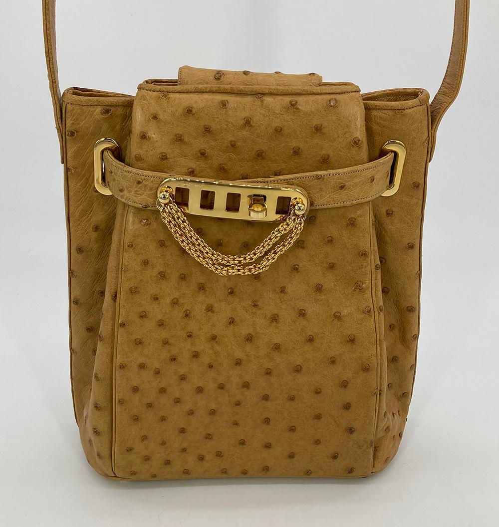 Vintage Judith Leiber Tan Ostrich Kelly Lock Shoulder Bag in excellent condition. Tan ostrich leather trimmed with gold hardware and adjustable buckle shoulder strap. Unique kelly style twist lock front and top magnetic snap closure opens to a tan