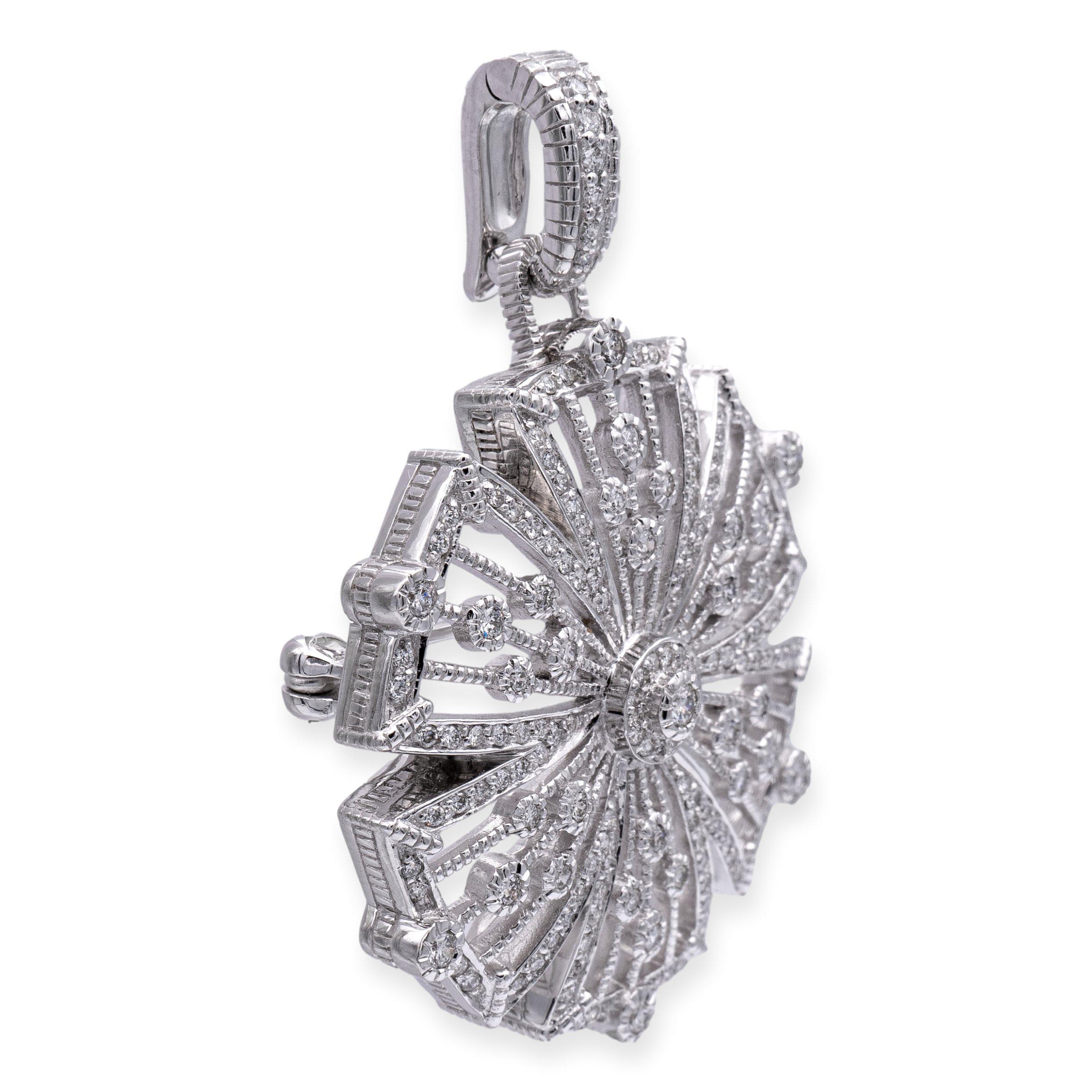 Vintage Judith Ripka brooch finely crafted in 18 karat white gold in an intricate design featuring delicate filigree open scrollwork in the shape of a captivating flower. Adorned with approximately 1.35 carats of round brilliant-cut diamonds, this