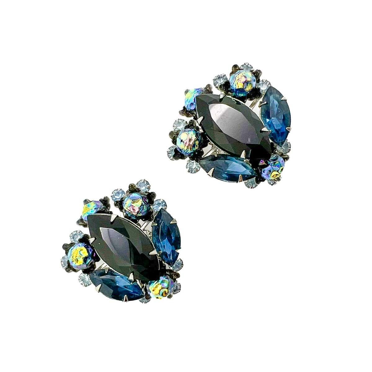 A pair of Vintage Judy Lea Navette  Earrings. A large black navette stone is surrounded with a remarkable myriad of fancy stones and beads all in black to navy hues. A rare and forever stylish find with incredible detail and craftmanship.

Founded