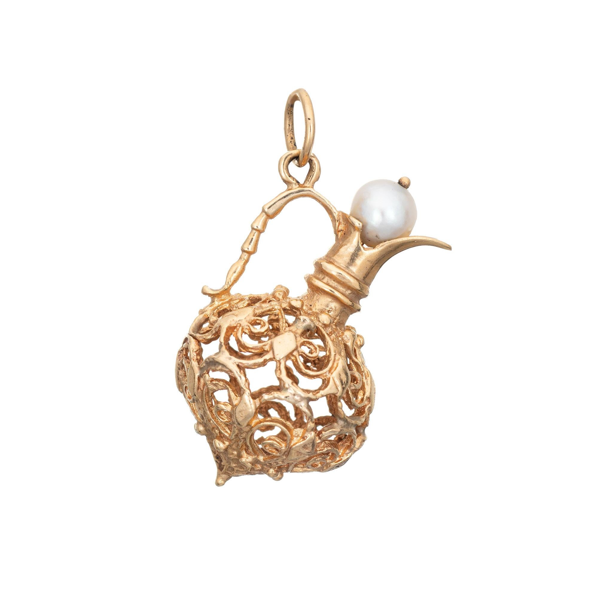 Finely detailed vintage jug pendant crafted in 14k yellow gold.  

One 5.8mm cultured pearl is set into the mount. 

The jug features an elaborate scrolled design. Ideal worn as a pendant or on a charm bracelet.

The charm is in very good condition.