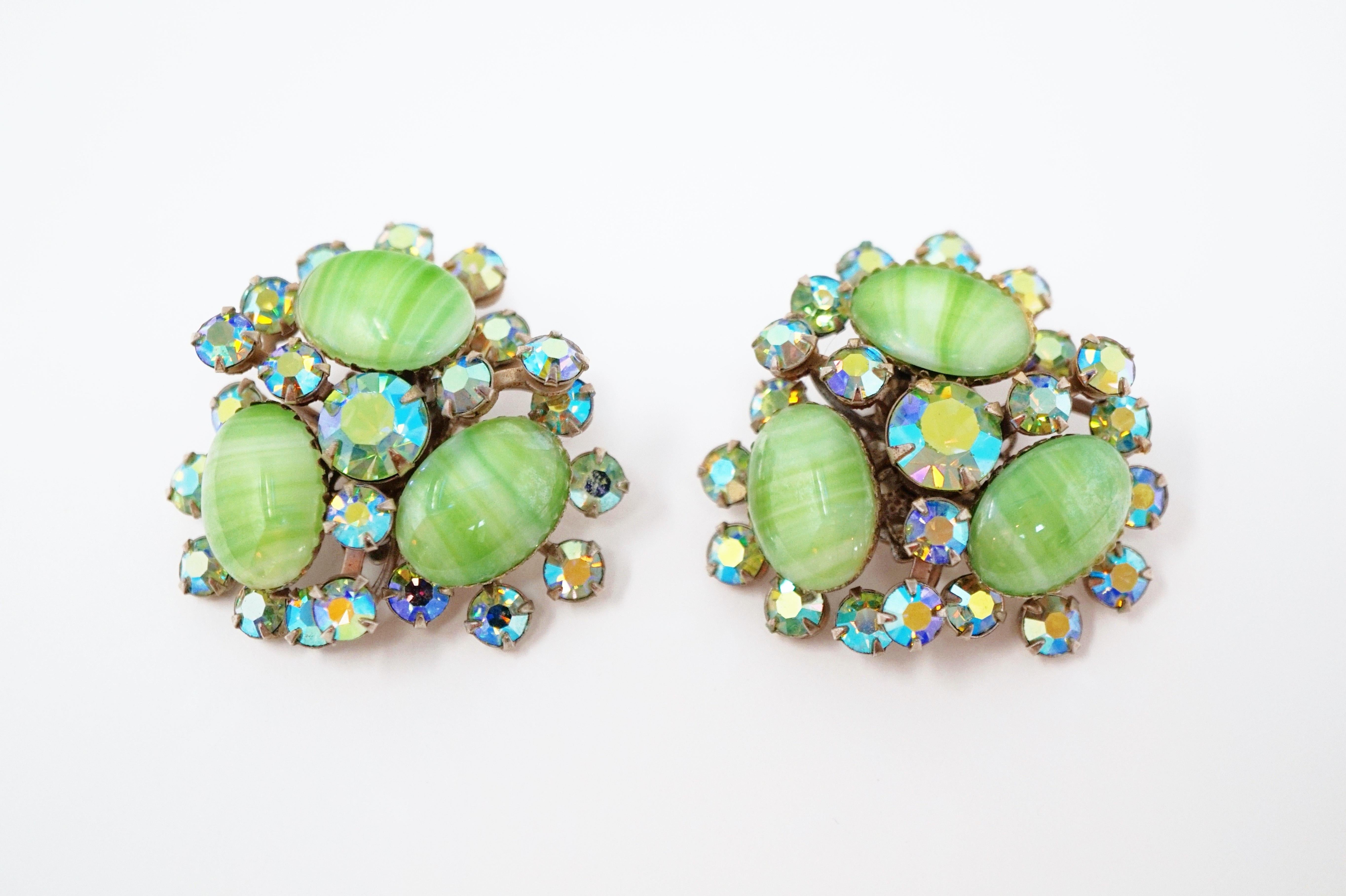 These stunning vintage Juliana-style statement earrings from the mid-century era make a truly unique statement! A three-dimensional cluster of mint green Givre art glass stones, accented with Aurora Borealis rhinestones prong set in silver tone