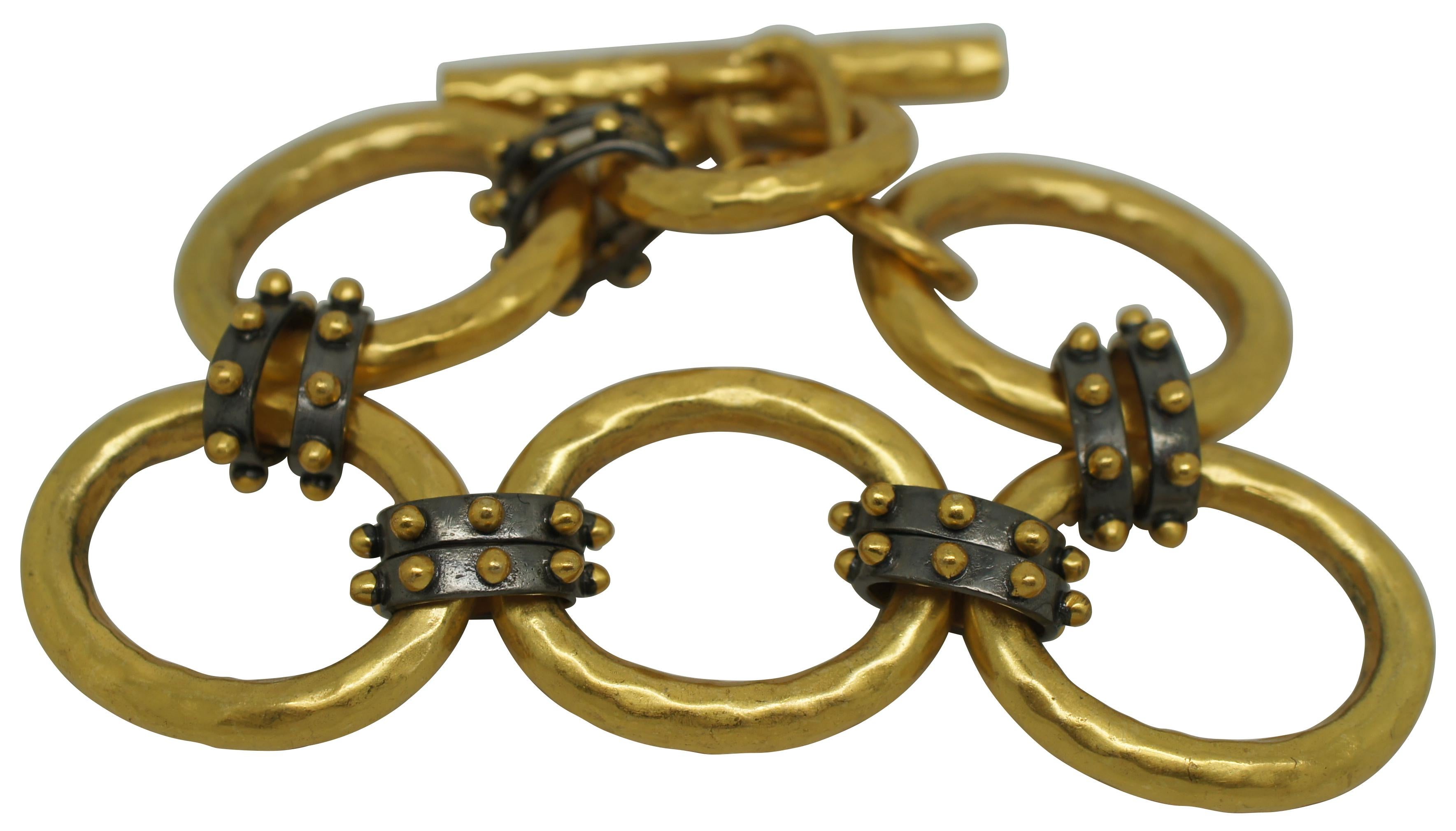 Vintage SoHo Link Bracelet by Julie Vos, featuring lightly hammered 24K gold plated oval chain links connected with dark studded connecting links. Toggle clasp. 

Studded mixed metal connecting links mingle with lightly hammered ovals to create a