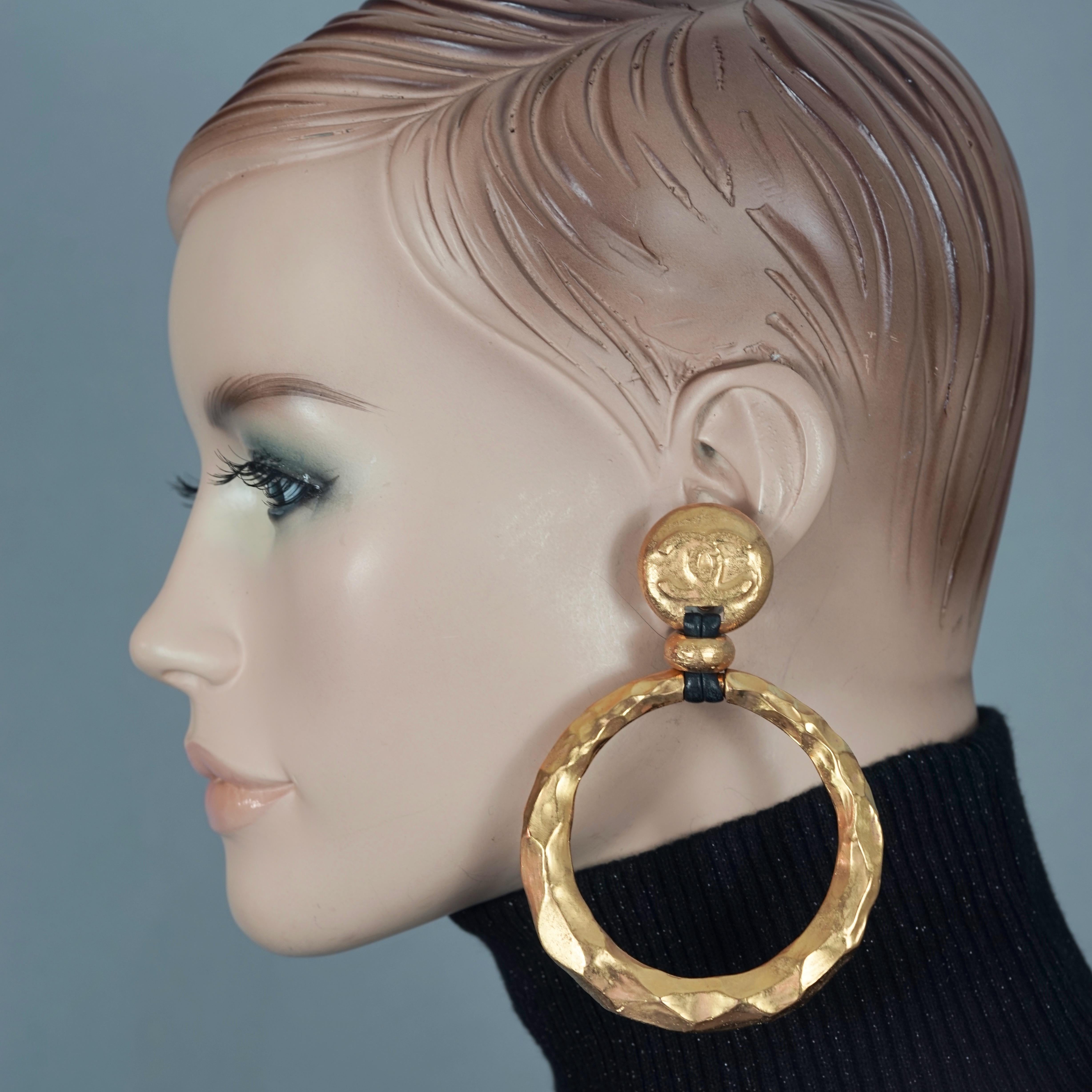 Vintage Jumbo CHANEL Logo Hammered Hoop Dangle Earrings As Seen on Beyonce

Measurements:
Height: 3.93 inches (10 cm)
Diameter: 2.75 inches (7 cm)
Weight per Earrings: 17 gram

Features:
- 100% Authentic CHANEL.
- Jumbo CC logo hoop earrings with