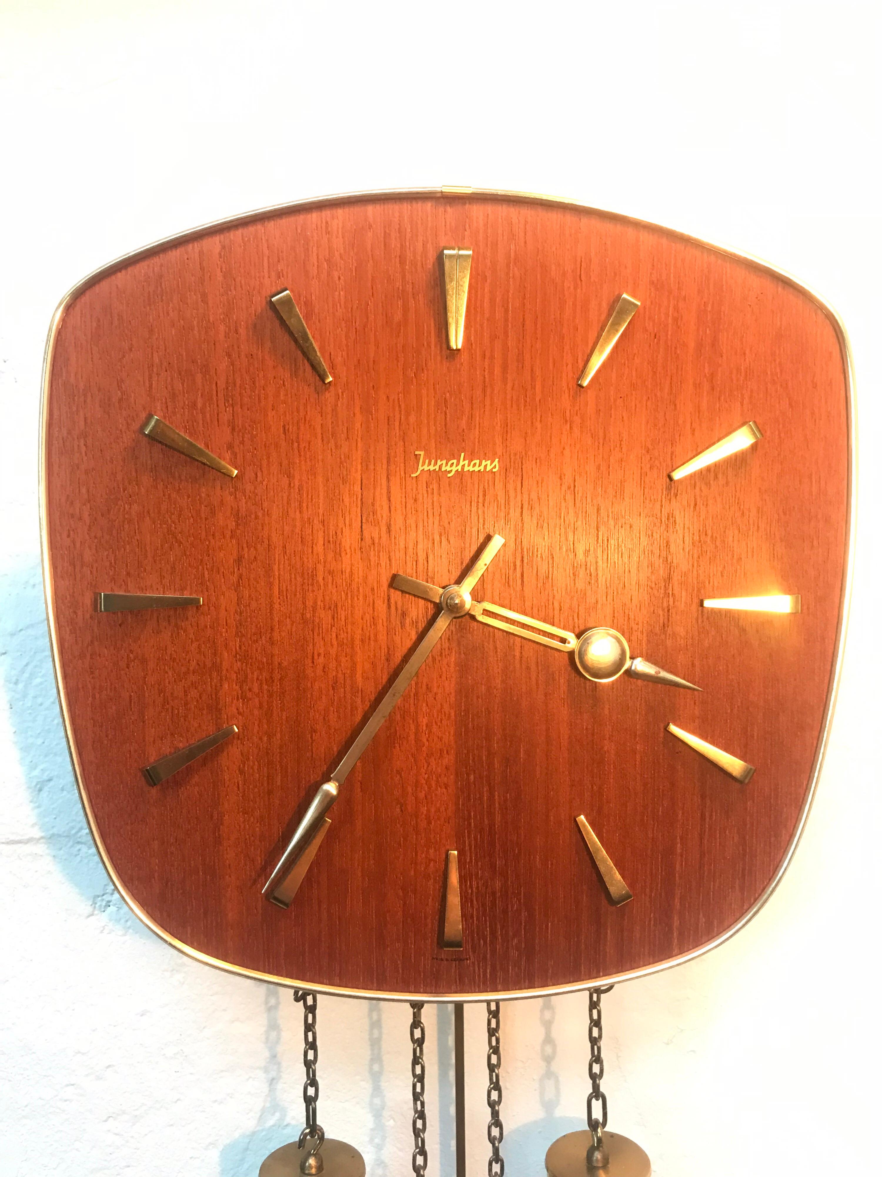 Vintage Junghans pendulum wall clock from the 1960s In Teak with brass fittings.
In lovely working condition and with chimes on the half and whole hour that can be switched off if so desired.
Worldwide shipping responsibly and professionally