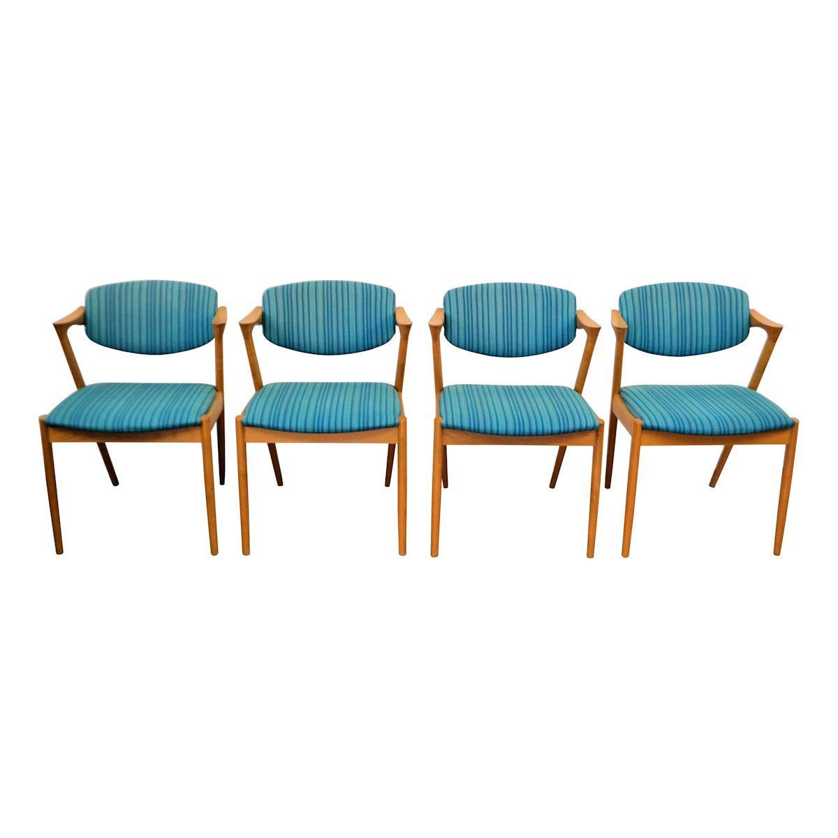 Set of four Danish modern model #42 dining chairs designed by Kai Kristiansen for Schou Andersen SVA Møbler. The iconic model #42, also known as the “Z chair”, offers a great level of comfort by way of its pivoting backrest. The chairs feature solid