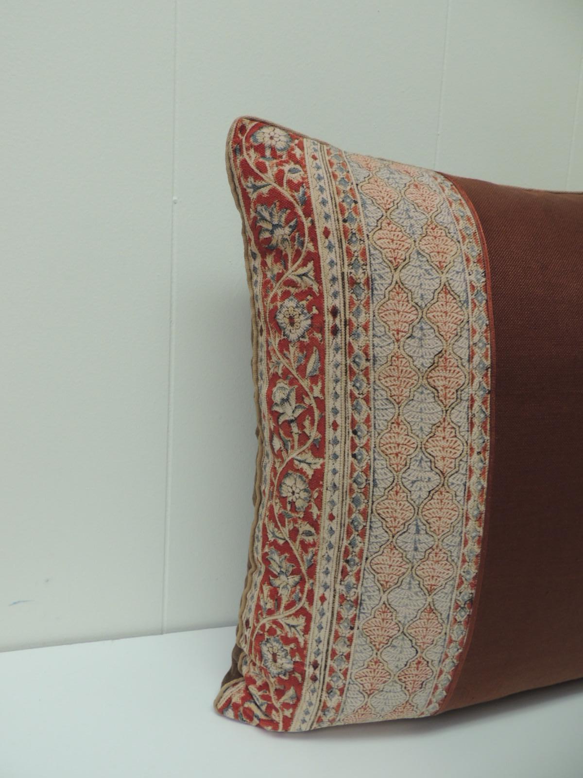 Indian hand-blocked textile decorative pillow. Hand-blocked border at the bottom of the Kalamkari decorative pillow framed with rust-colored textured linen and embellished with a rust color cord at the seams. Small tan cotton piping all around and