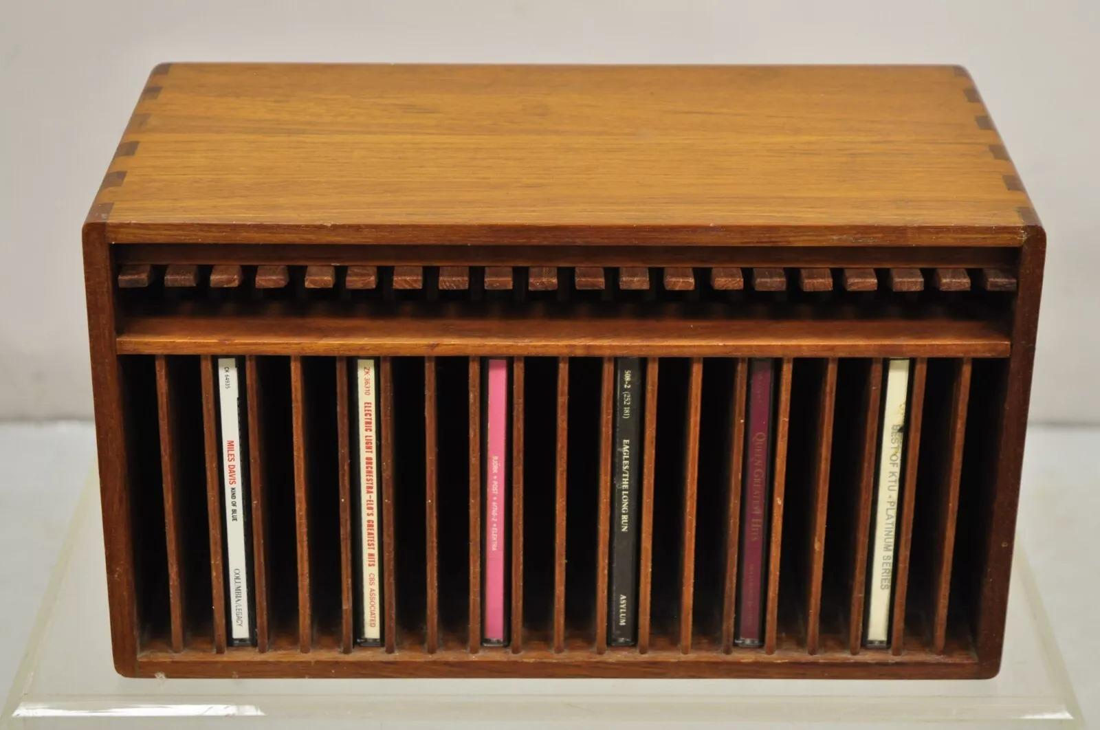 Vintage Kalmar Designs Teak Wood Mid Century Modern 20 Slot CD Rack Holder Organizer. Item features solid teak wood dovetailed construction with wooden levers that push down and the CD pops out. Circa Late 20th Century. Measurements: 7.5