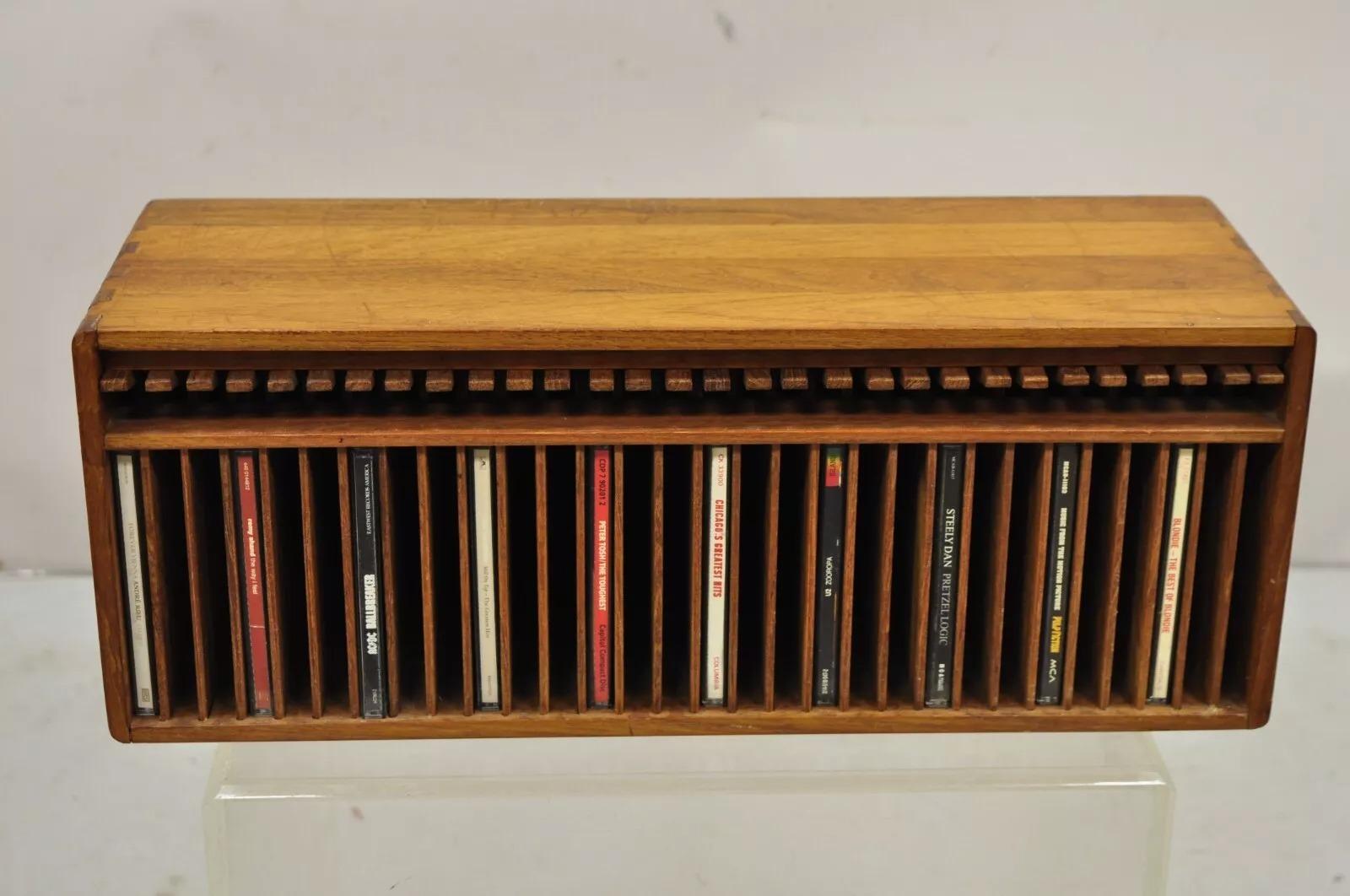 Vintage Kalmar Teak Wood Mid Century Modern 30 Slot CD Rack Holder Organizer (C). Item features solid teak wood dovetailed construction with wooden levers that push down and the CD pops out. Circa Late 20th Century. Measurements: 7.5
