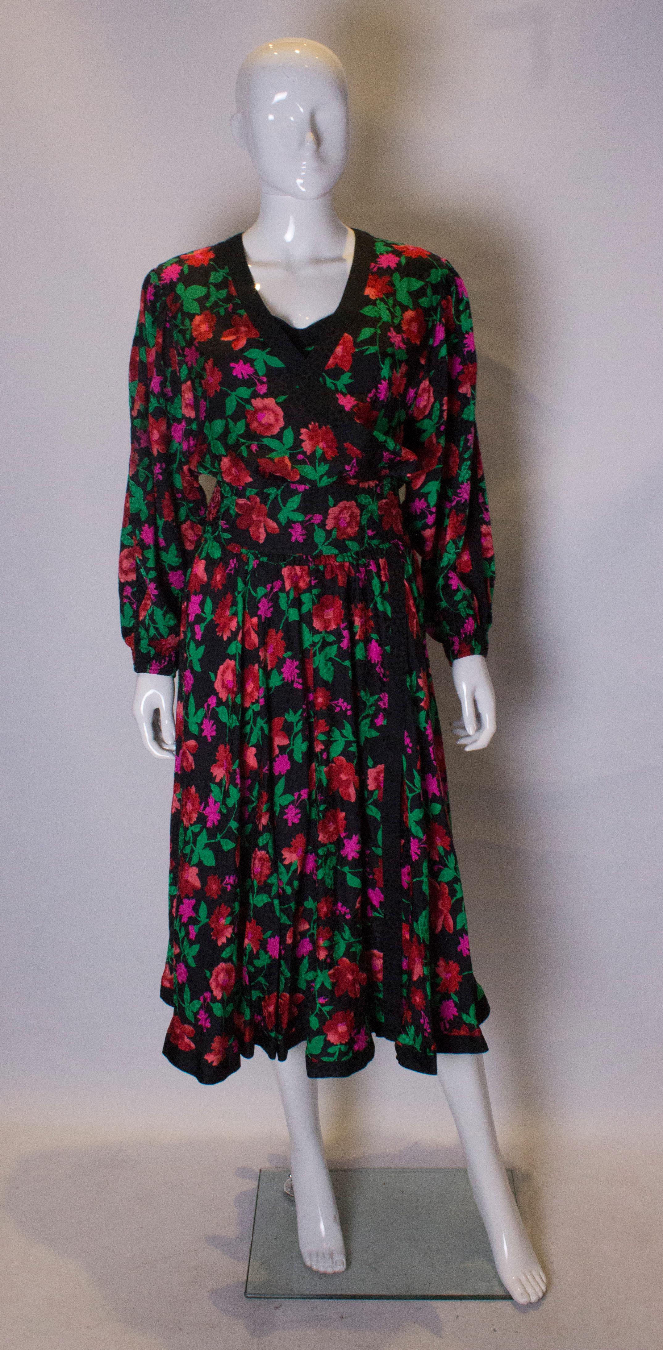 A great dress by Kanga Collection by Dale Tyron. The dress is made of a high quality silk, in a floral print with a black background with a red, green and pink print.  It has an elasticated waist , that stretches from 24'' to 30'' and can be covered