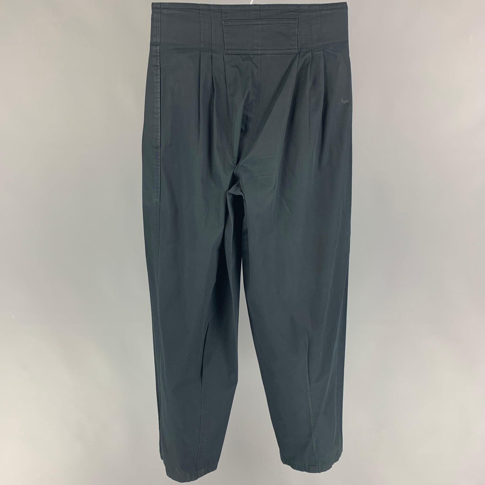 Vintage KANSAI MEN pants comes in a black cotton featuring a high waisted style, pleated, asymmetrical, and a zip fly closure. Made in Japan. 

Very Good Pre-Owned Condition.
Marked: Size tag removed.

Measurements:

Waist: 28 in.
Rise: 13