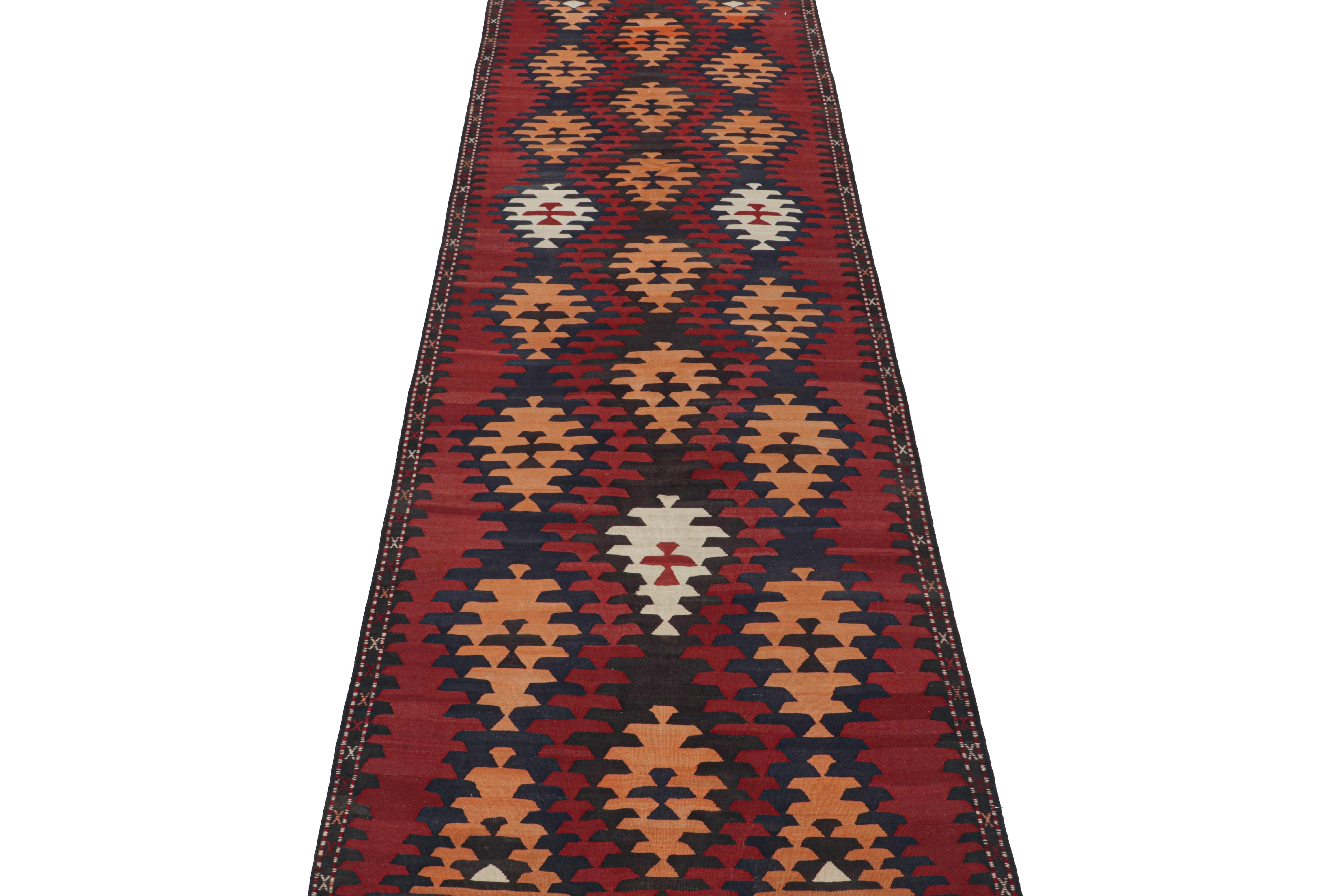 This vintage 5x14 Persian Kilim is a tribal gallery runner believed to originate in the Karadagh region.

Handwoven in wool circa 1950-1960, its design favors a clean approach to traditional geometric patterns and particularly rich colors. Keen