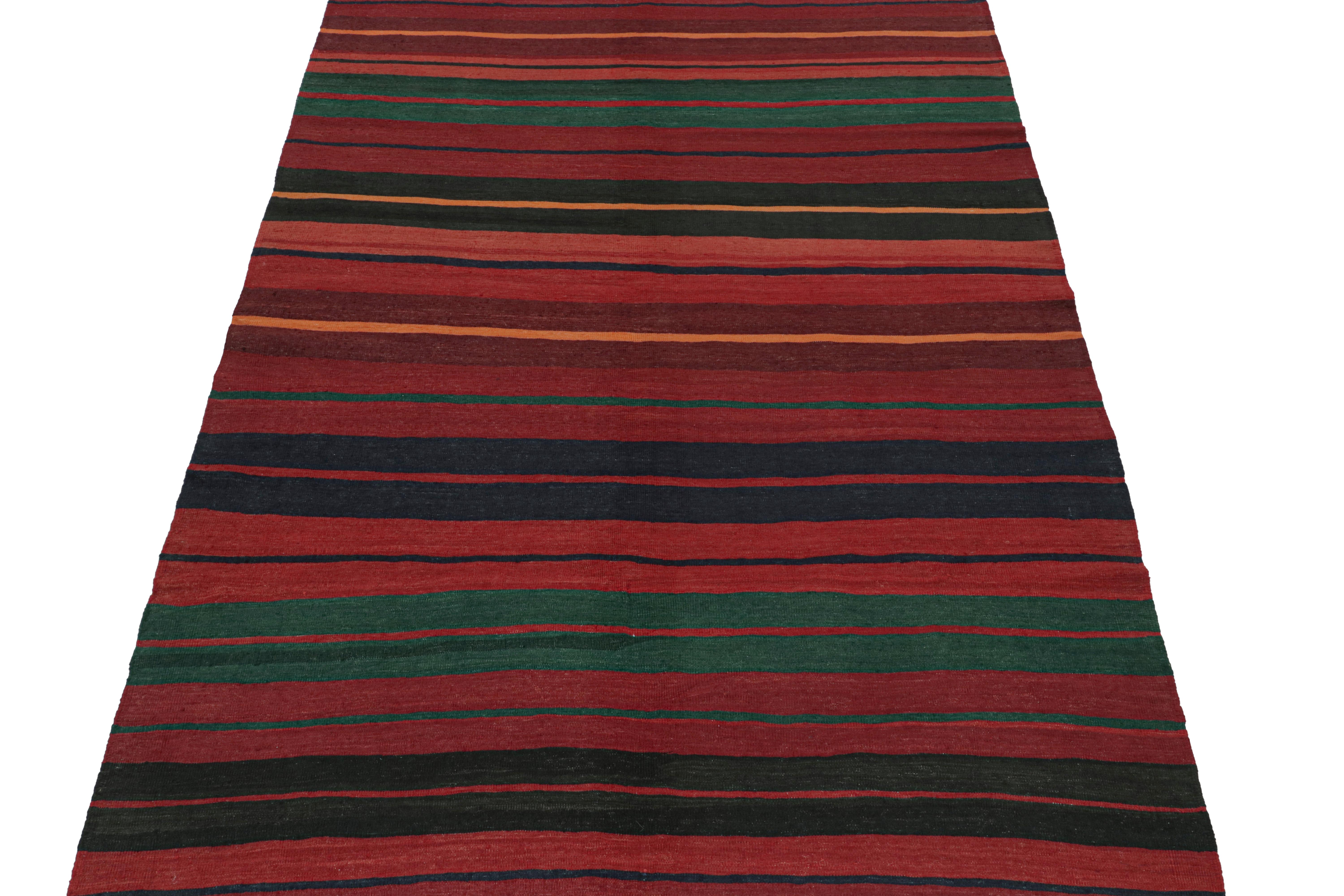 This vintage 7x11 Persian Kilim is believed to be a tribal rug of Karadagh—a mountainous region known for its Craft. Handwoven in wool, it originates, circa 1950-1960.

Its design enjoys a rich burgundy with teal, navy blue, black, and orange