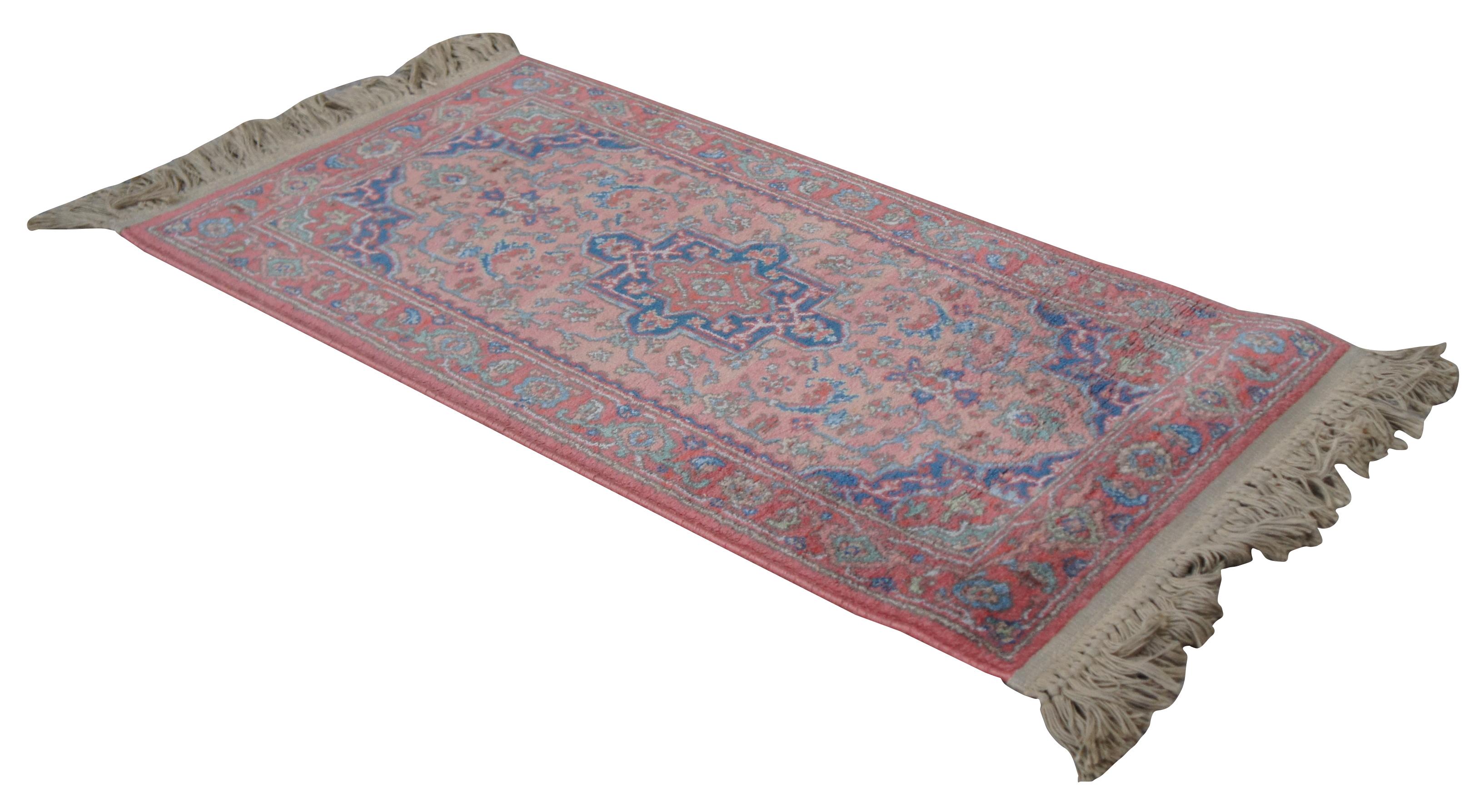 Karastan Design No. 736, Medallion Serapi. Made of 100% Wool with a pink background covered in shades of blue and pink. Measures: 2.2 x 4'.