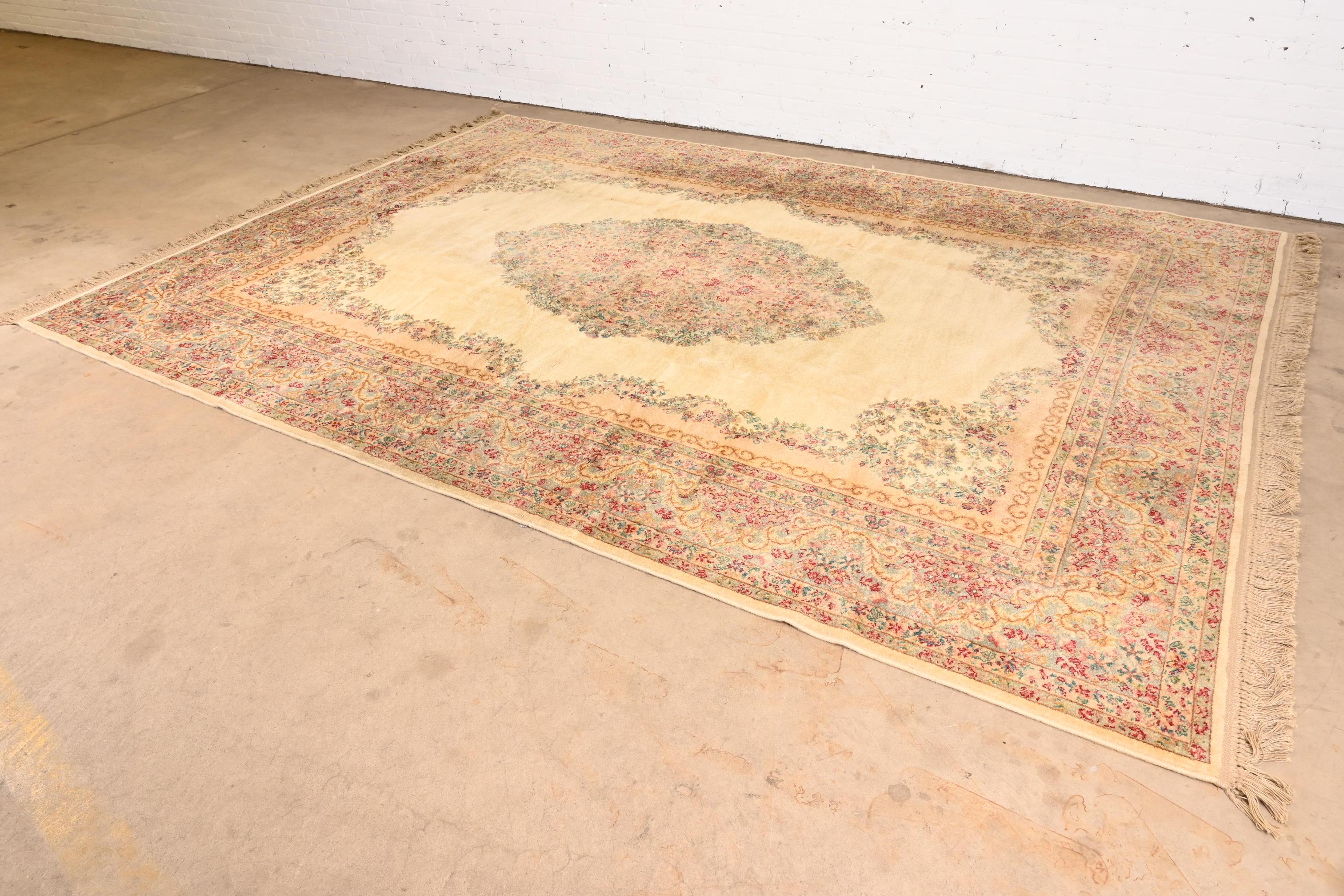 A gorgeous vintage Persian Kirman style room size wool area rug

By Karastan

USA, Mid-20th Century

Classic design with floral sprays and bouquets. Predominant colors in cream, pink, and light blue.

Measures: 8ft 7in x 12ft 9in

Good original