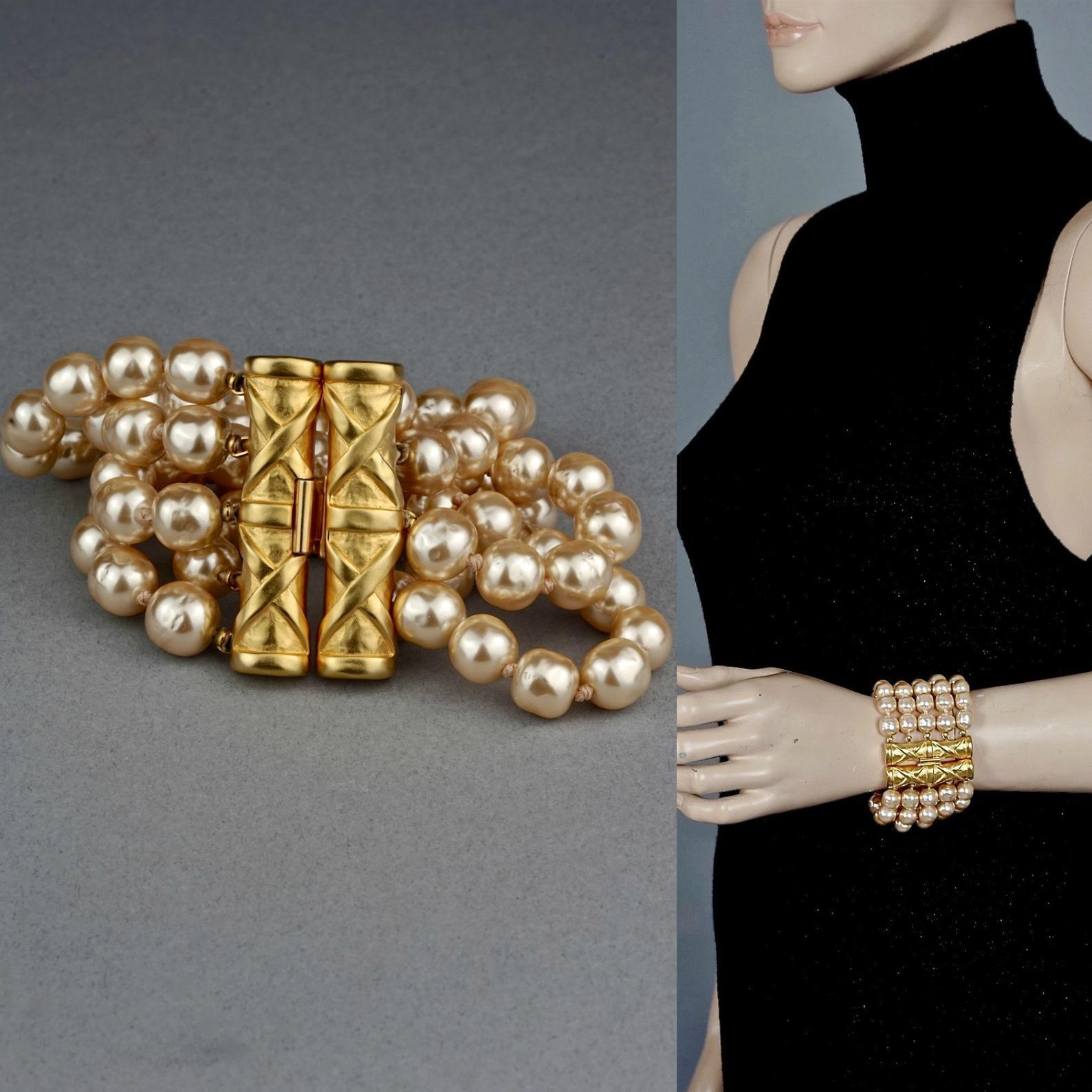Vintage KARL LAGERFELD Bamboo Multi Strand Pearl Cuff Bracelet

Measurements:
Height: 2.16 inches (5.5 cm)
Wearable Length: 7.28 inches (18.5 cm)

Features:
- 100% Authentic KARL LAGERFELD.
- 5 Strands of cream and gold baroque glass pearls.
-