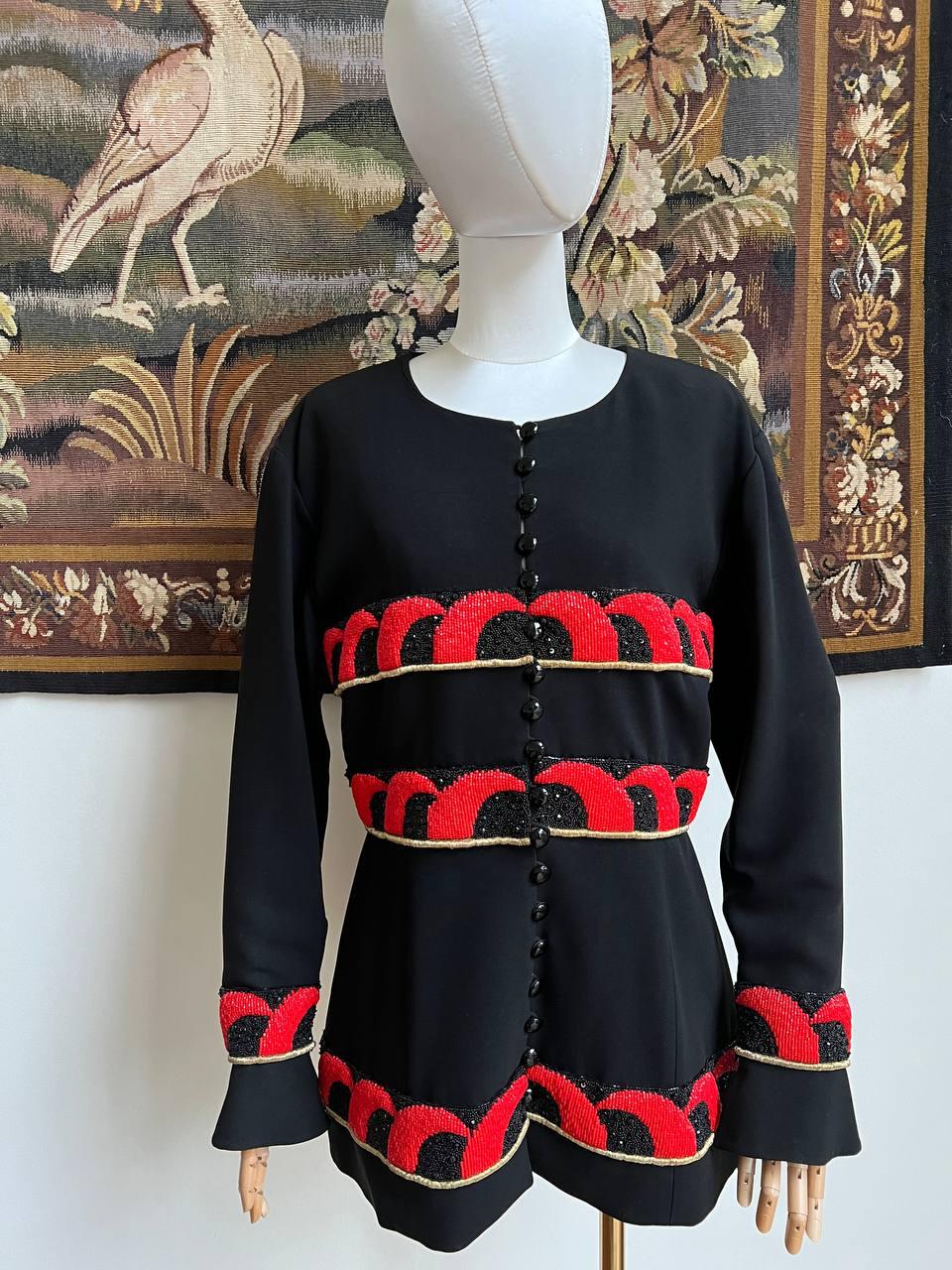 Vintage black evening jacket by Karl Lagerfeld decorated with beaded and sequin embroidery in black and red colors. 
From 1980's collection. 
Collarless. 
Button closure.
Size: 42 (L)
Condition: very good, minor pull at front
Measurements: