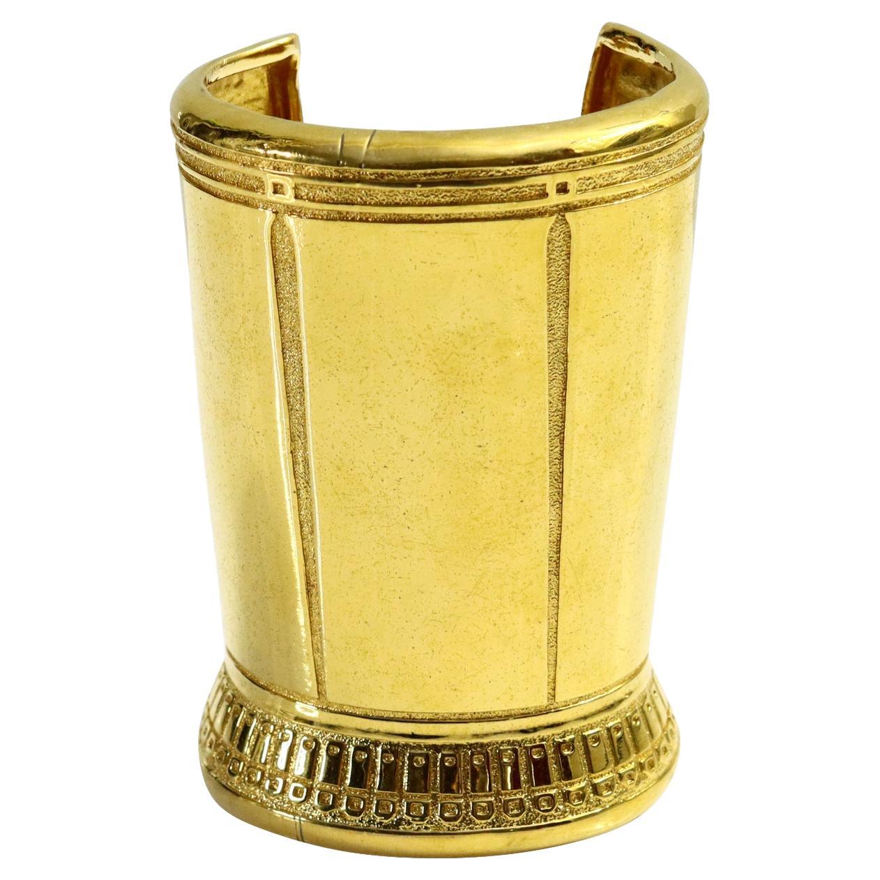 Vintage Karl Lagerfeld Large Gold Tone Cuff Bracelet.  Unsigned and Gorgeous but very Lagerfeld.  Substantial and heavy with lots of detail.  If you are smaller I have a way to make this fit so let me know and I will write you and let you know.  I
