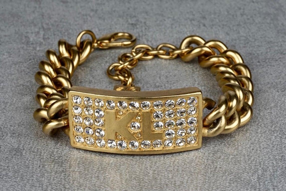 Vintage KARL LAGERFELD Logo ID Name Plate Chain Bracelet

Measurements:
Height: 0.78 inch (2 cm)
Wearable Length: 7.87 inches to 9.64 inches (20 cm to 24.5 cm)


Features:
- 100% Authentic KARL LAGERFELD.
- Chunky ID plate chain bracelet.
- KL logo