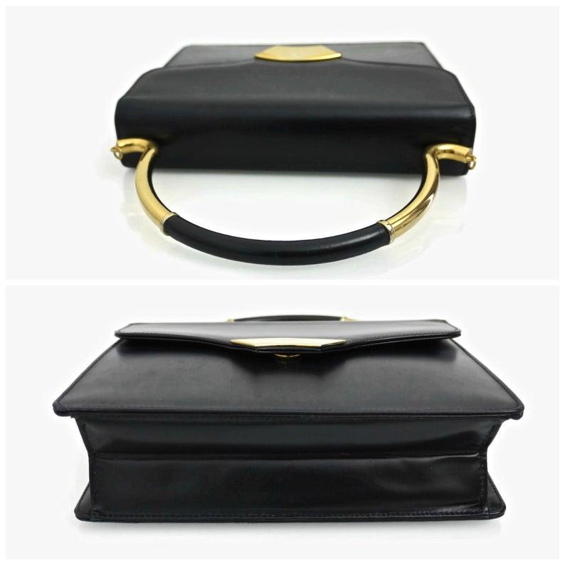Vintage KARL LAGERFELD Navy Blue Kelly Bag

Measurements:
Height: 11 inches (including handle)
Height: 7 inches (without the handle)
Width: 9 inches
Depth: 2 6/8 inches

Features:
- 100% Authentic KARL LAGERFELD.
- Navy blue kelly bag.
- Rigid top