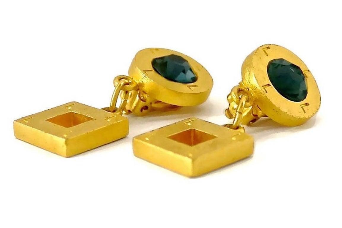 Vintage KARL LAGERFELD KL Logo Diamond Earrings

Measurements:
Height: 1.89 inches (4.8 cm)
Width: 1.26 inches (3.2 cm)
Weight per Earring: 17 grams

Features:
- 100% Authentic KARL LAGERFELD.
- Diamond shaped earrings with raised KL logo.
- Gold