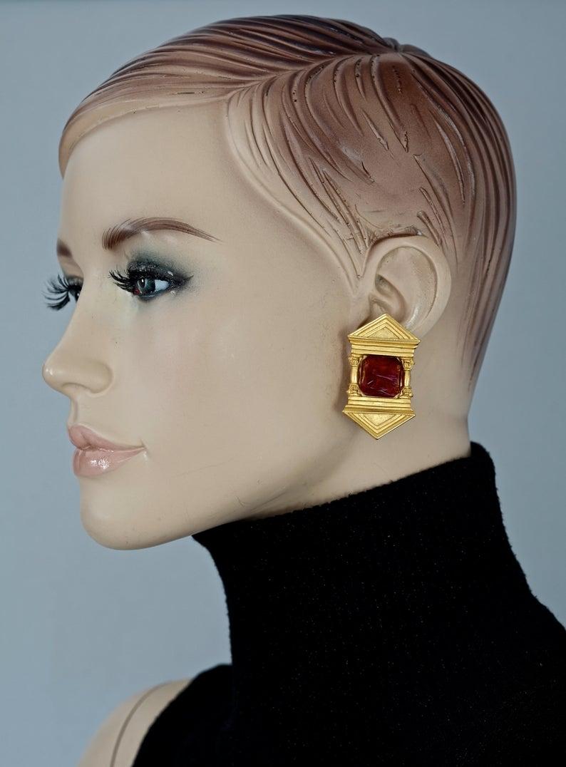 Vintage KARL LAGERFELD Upside Down Greek Temple Door Earrings

Measurements:
Height: 1.85 inches (4.7 cm)
Width: 1.06 inches (2.7 cm)
Weight per Earring: 23 grams

Features:
- 100% KARL LAGERFELD.
- Upside down Greek temple door motif with glass
