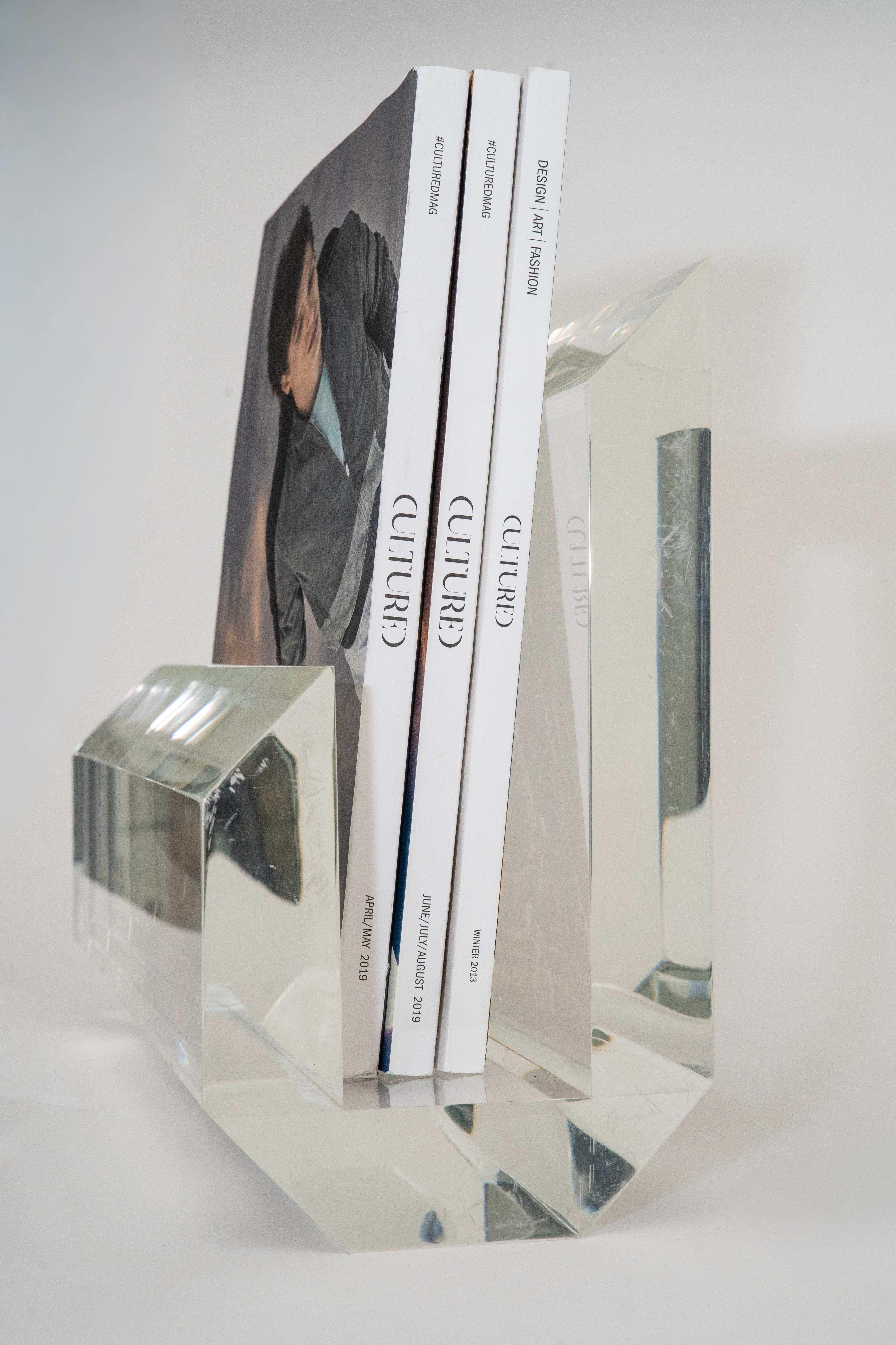 This ultra chic and fabulous thick walled transparent lucite magazine stand or rack is attributed to the designer: Karl Springer. it is from the 80's. 
It came from a home filled with Karl Springer furniture, lamps and objects.
It is heavy, modern