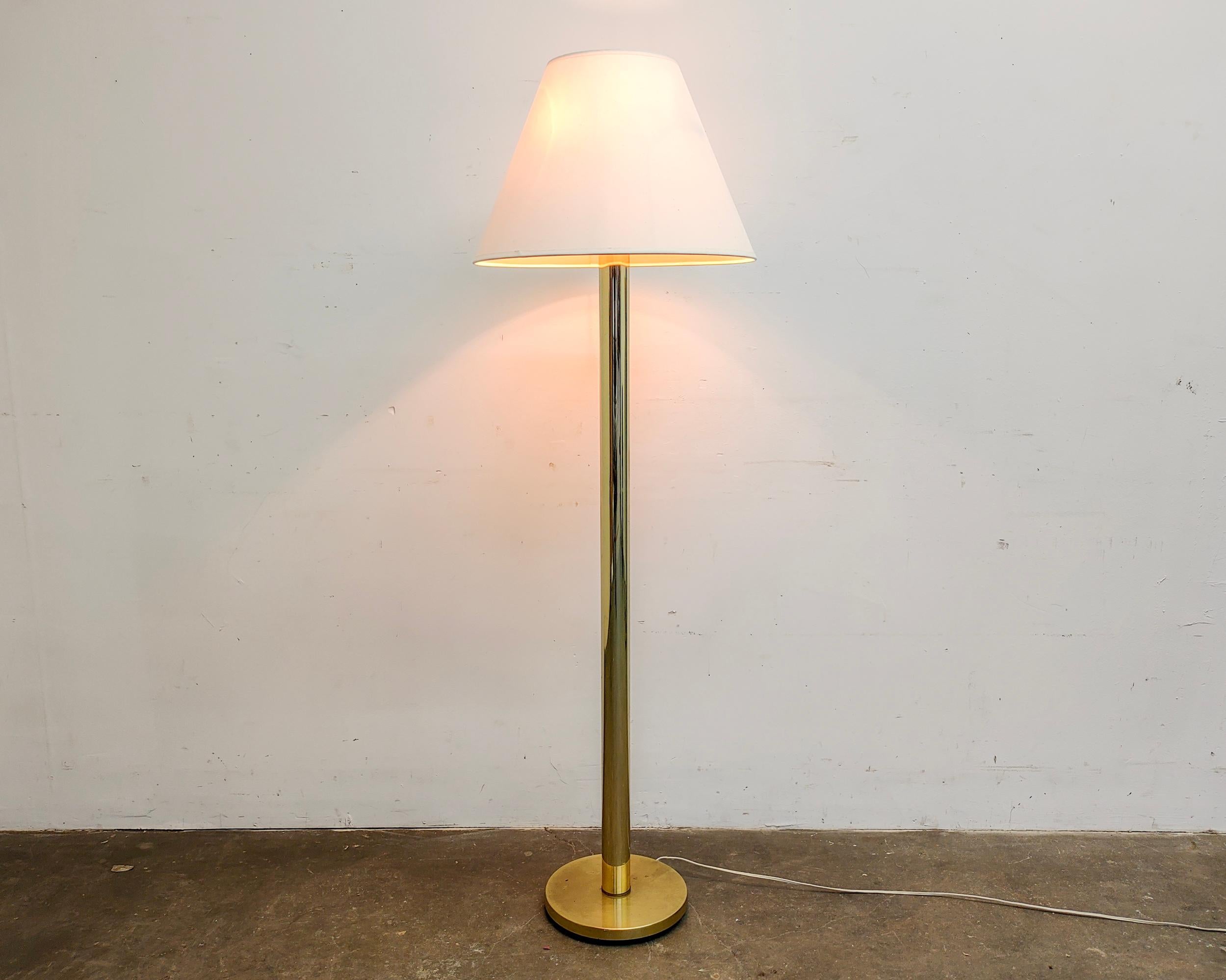 Minimal brass column floor lamp by Karl Springer for Koch and Lowy circa 1970. Two lights with individual on/off pull chains. Overall great condition, some very light wear consistent with vintage age. Original shade and finial has been