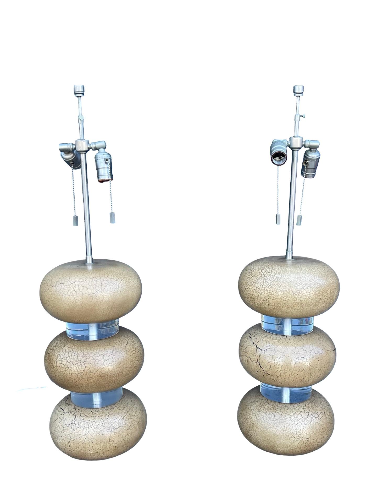 A wonderful rare pair of Karl Springer Clear Lucite and crackled yellow painted bubble lamps. A central stem in chrome hold two light sockets.