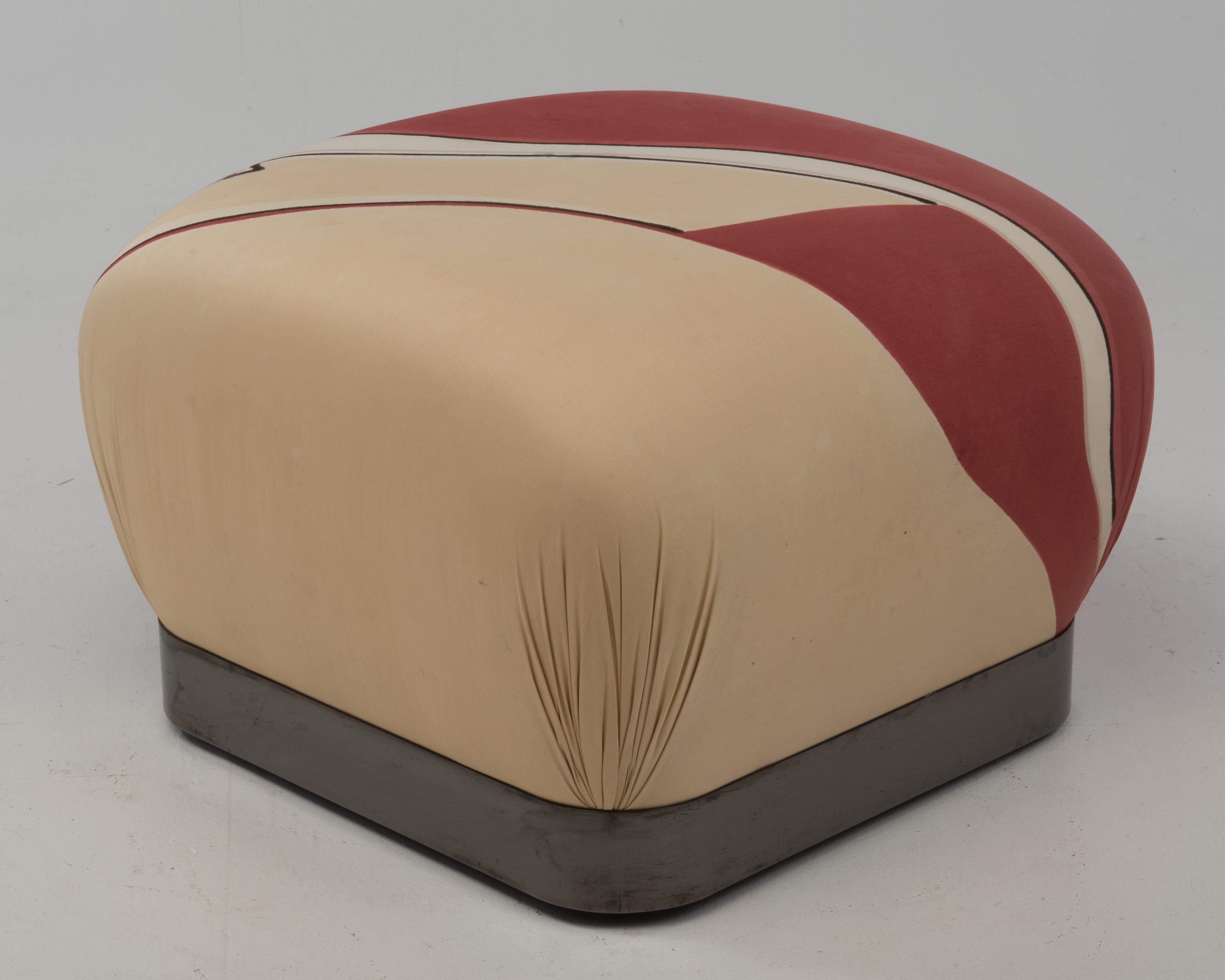 A vintage Karl Springer pouf ottoman in the original silk fabric. The ottoman is clean and shows very nicely. There is water staining to the top, the overhead photograph shows a few small areas where the colors have run. Measures: 24