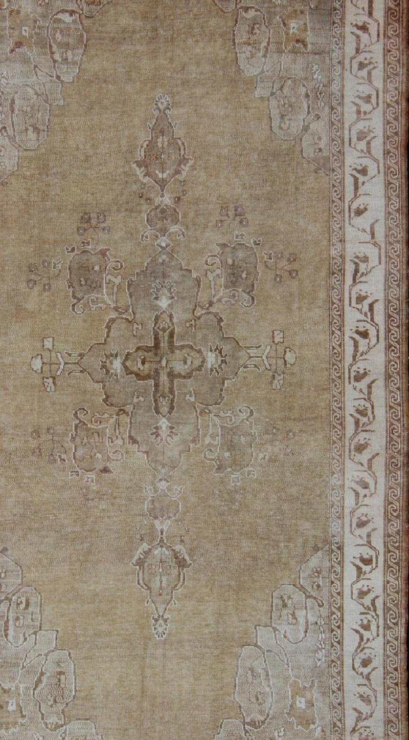 Hand-Knotted Vintage Turkish Kars Gallery Rug With Earthy Color Palette and Ivory Border For Sale